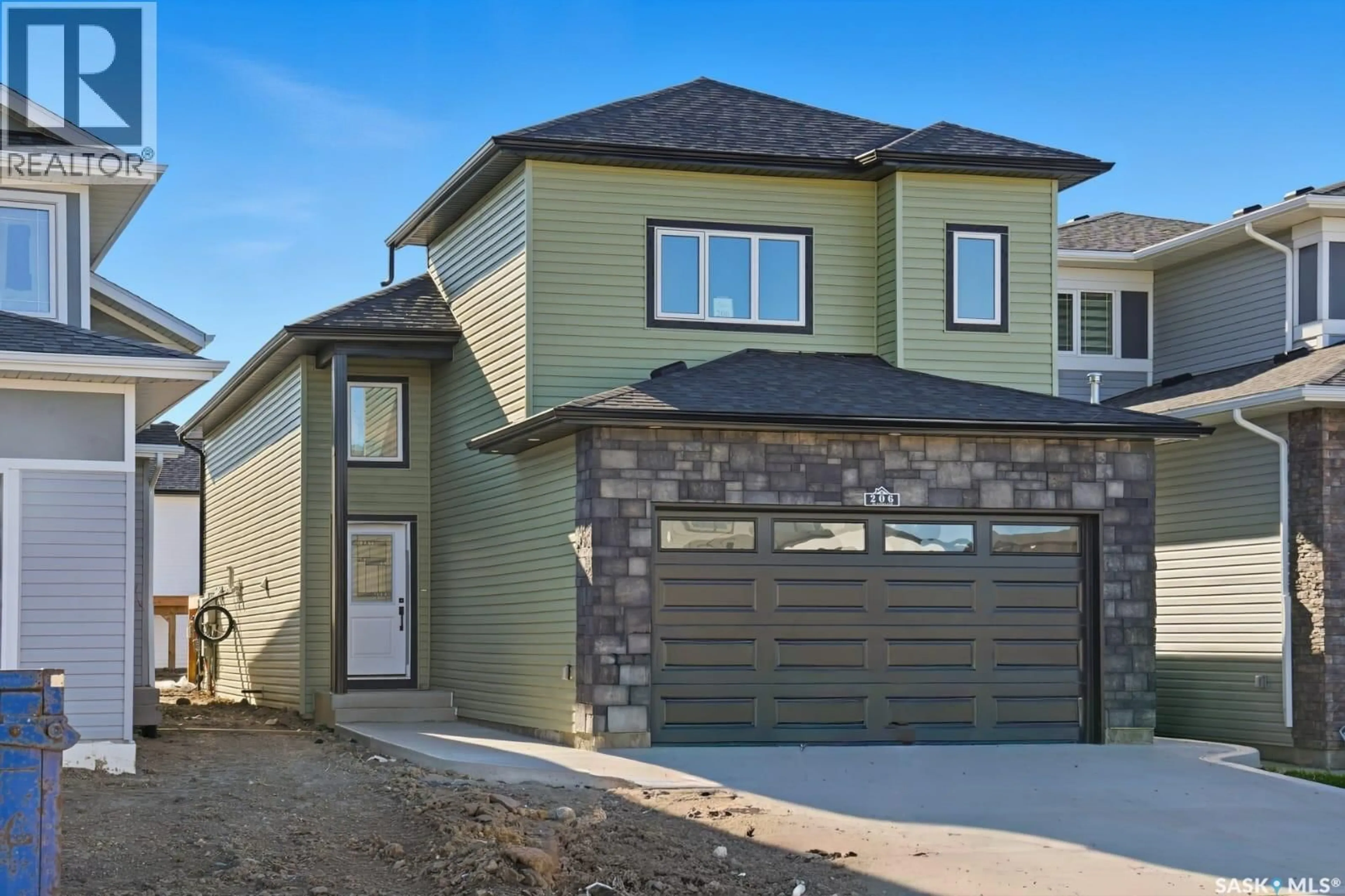 Home with vinyl exterior material, street for 206 SHARMA LANE, Saskatoon Saskatchewan S7K1K7