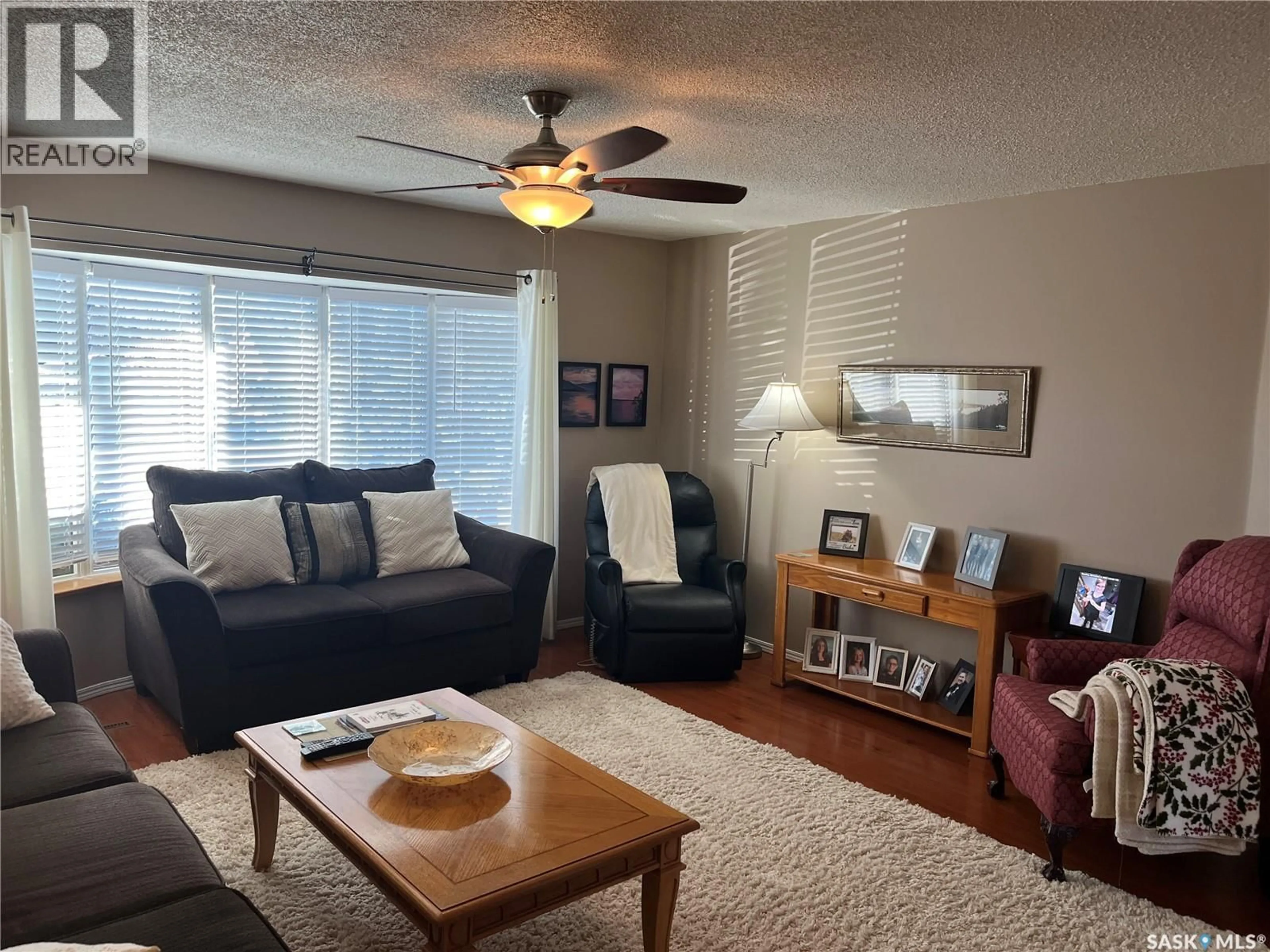 Living room with furniture, wood/laminate floor for 42 7TH STREET, Wadena Saskatchewan S0A4J0