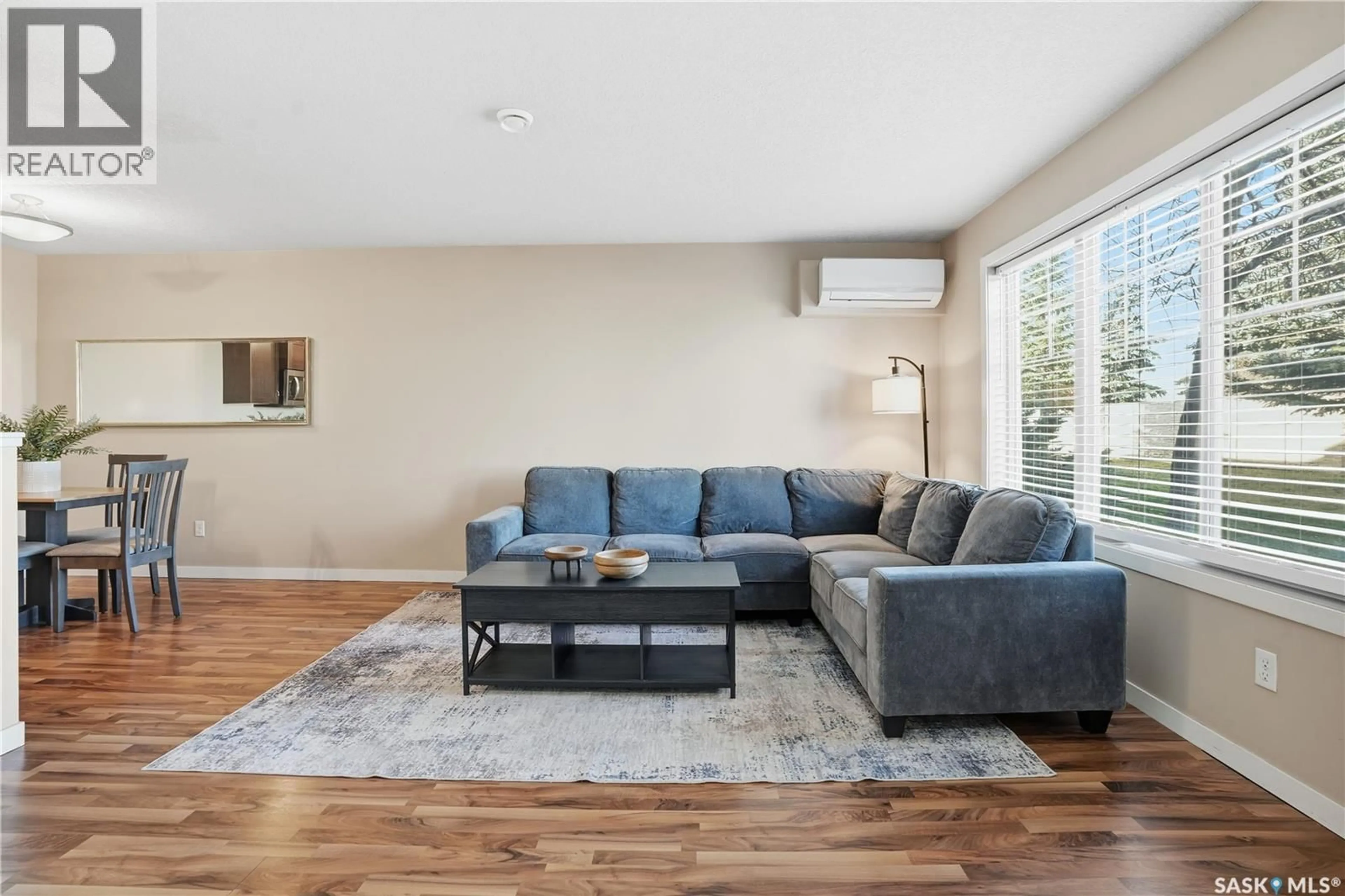 Living room with furniture, wood/laminate floor for 5521 - 116 BLAKE CRESCENT, Regina Saskatchewan S4X0J1