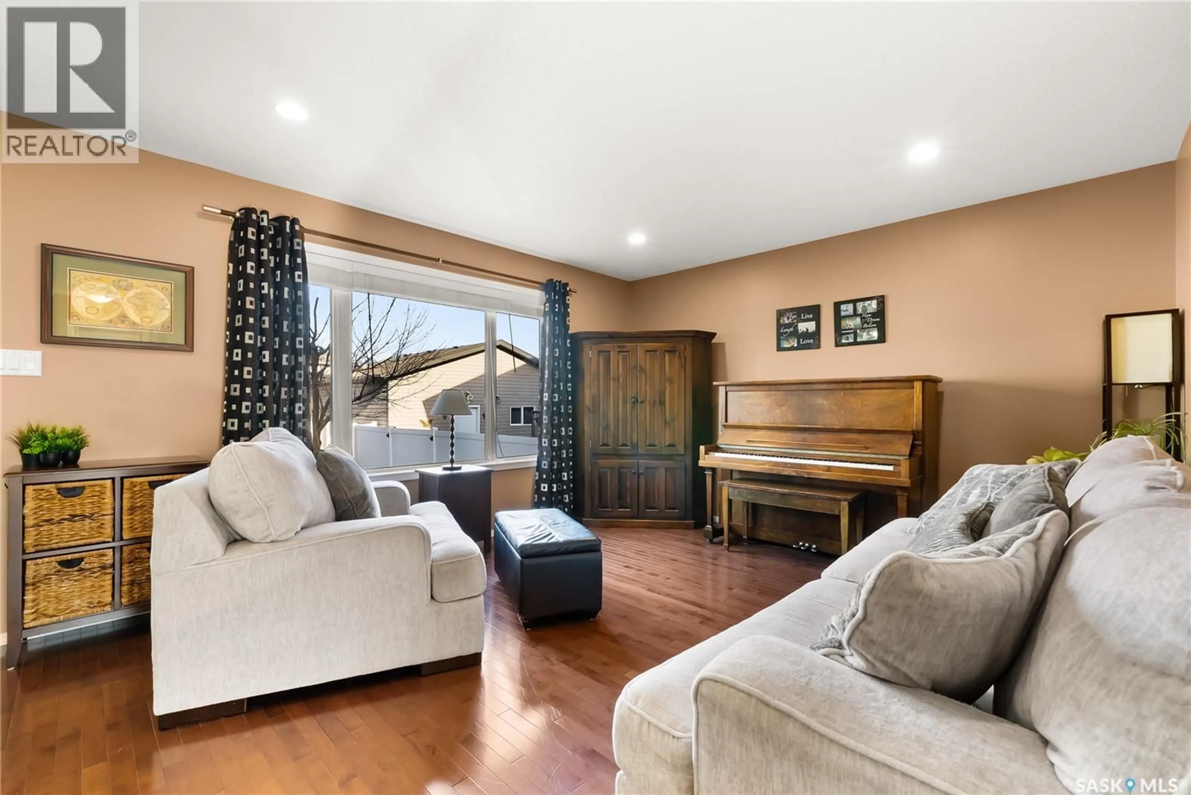 Living room with furniture, wood/laminate floor for 4466 NICURITY DRIVE, Regina Saskatchewan S4X0C3