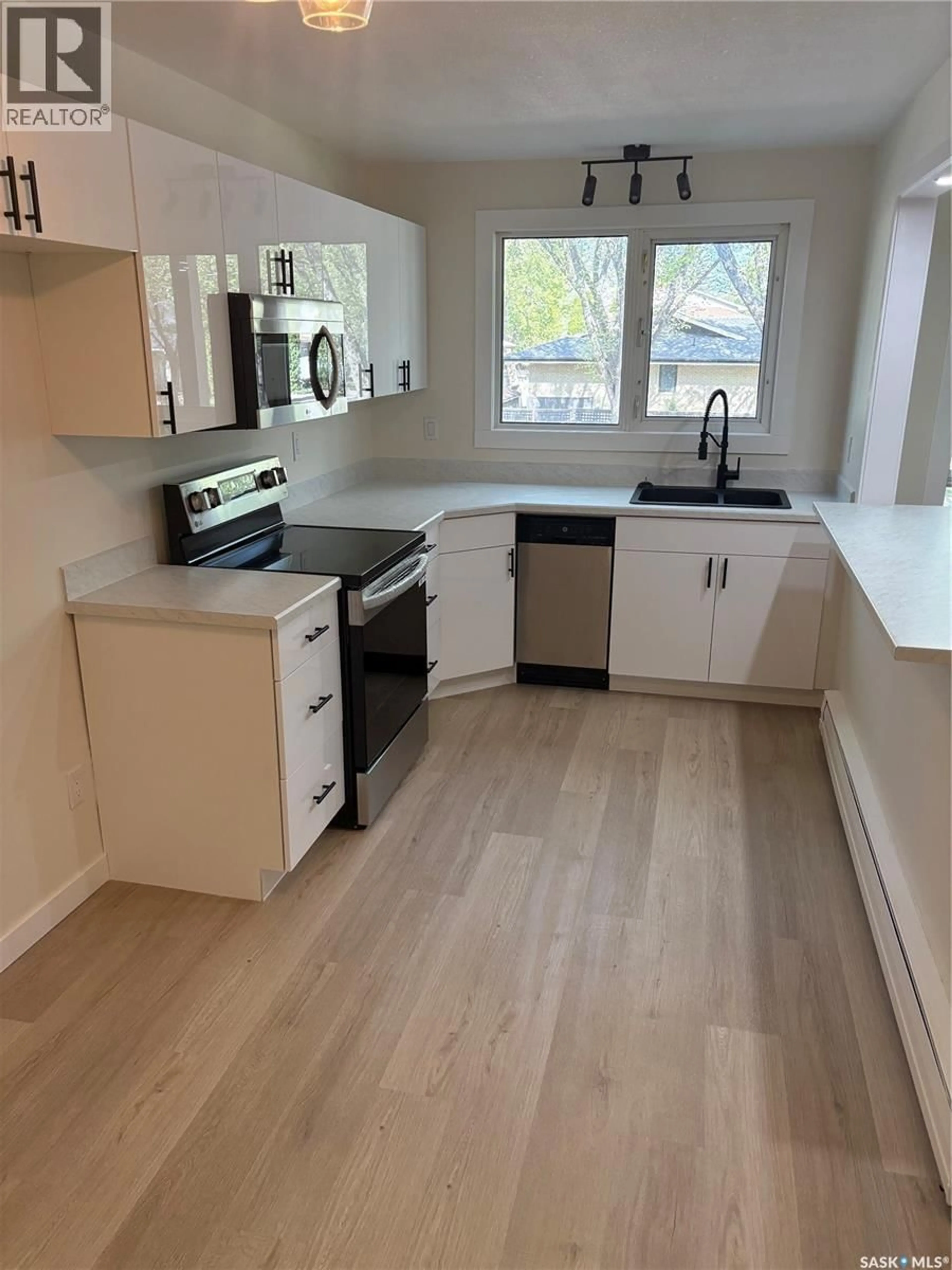 Open concept kitchen, wood/laminate floor for 35 42 SPENCE STREET, Regina Saskatchewan S4S4H4