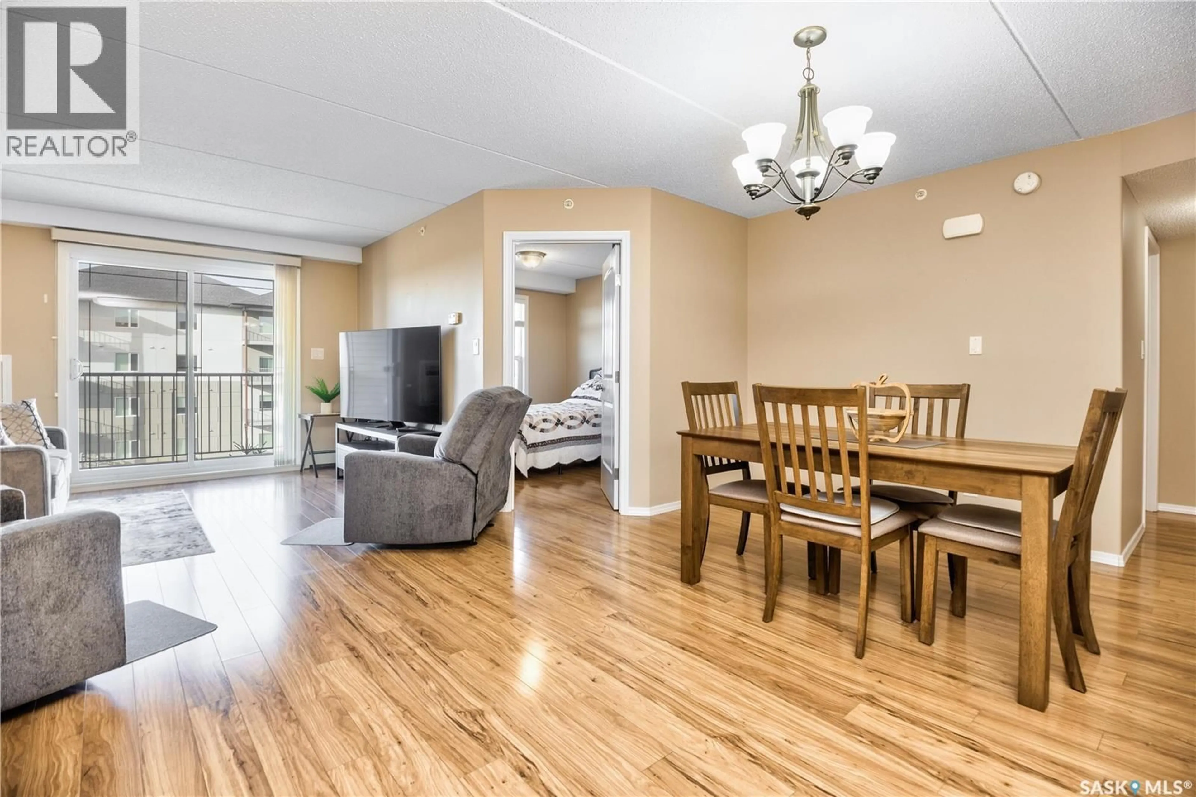 Living room with furniture, wood/laminate floor for 305 - 2781 WOODBRIDGE DRIVE, Prince Albert Saskatchewan S6V3Z9