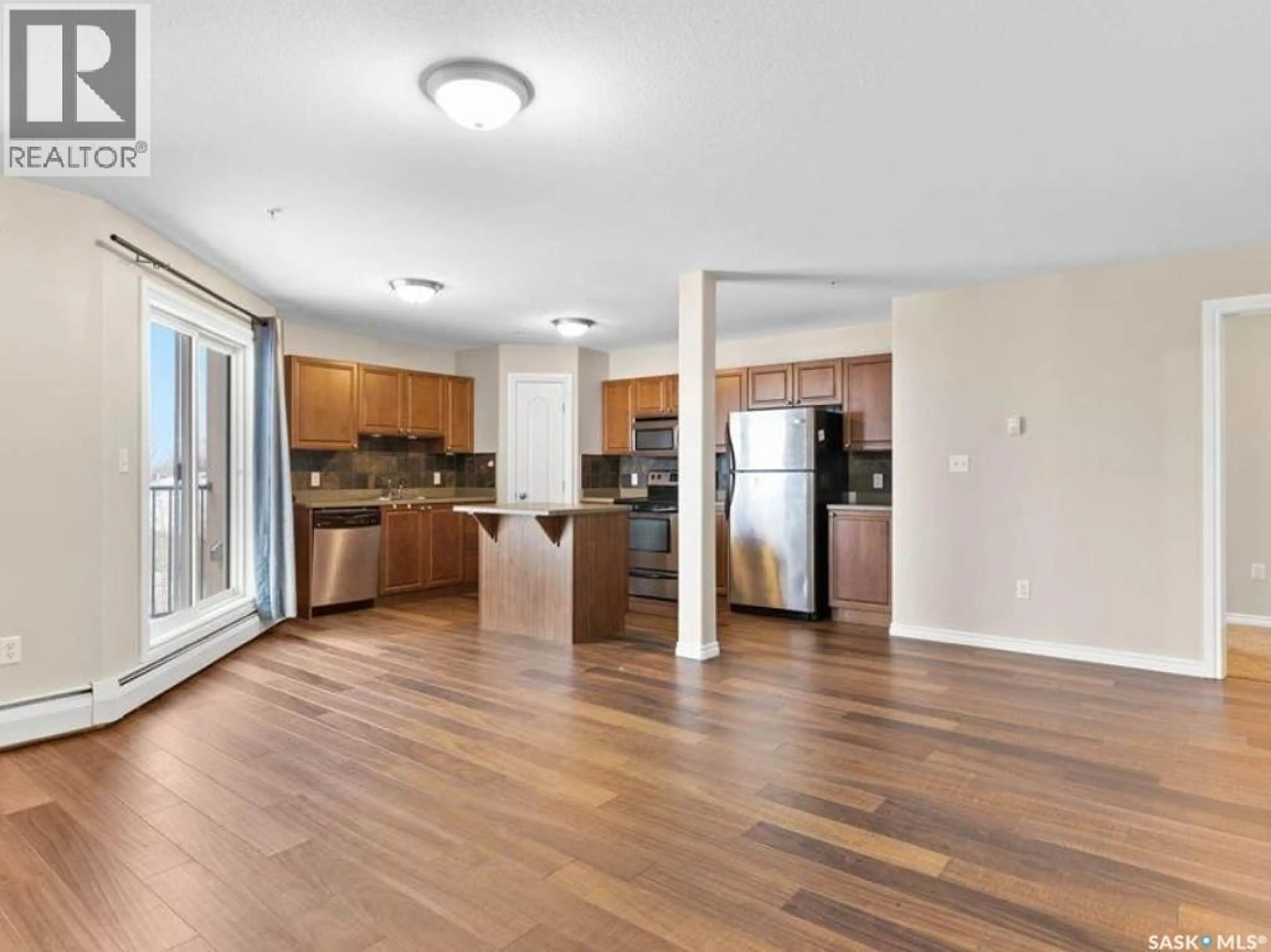 Open concept kitchen, wood/laminate floor for N - 202 100 1ST AVENUE, Warman Saskatchewan S0K0A1