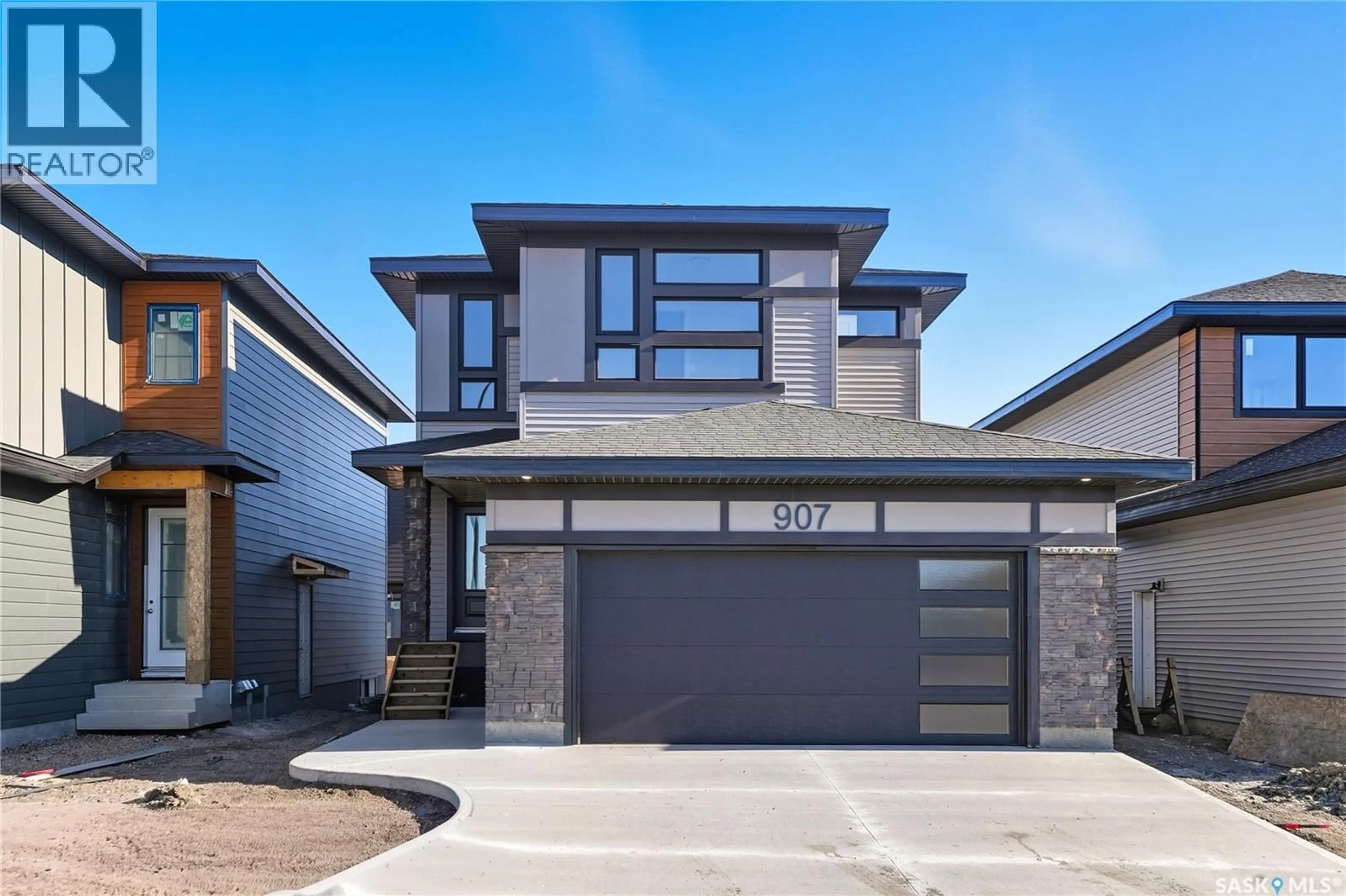 Home with brick exterior material, street for 907 TRAEGER MANOR, Saskatoon Saskatchewan S7V1V8