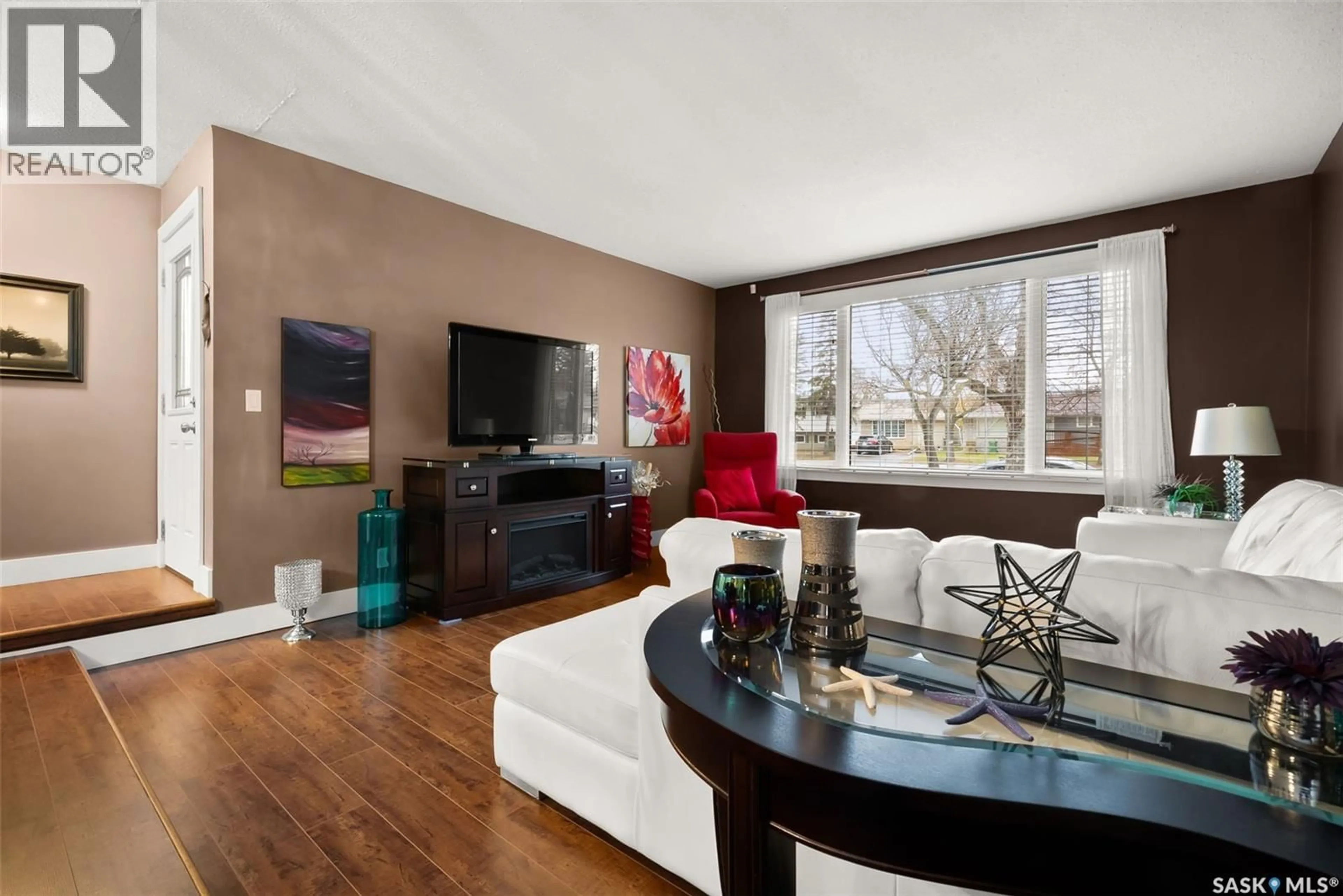 Living room with furniture, wood/laminate floor for 129 MCCARTHY BOULEVARD, Regina Saskatchewan S4R5S2