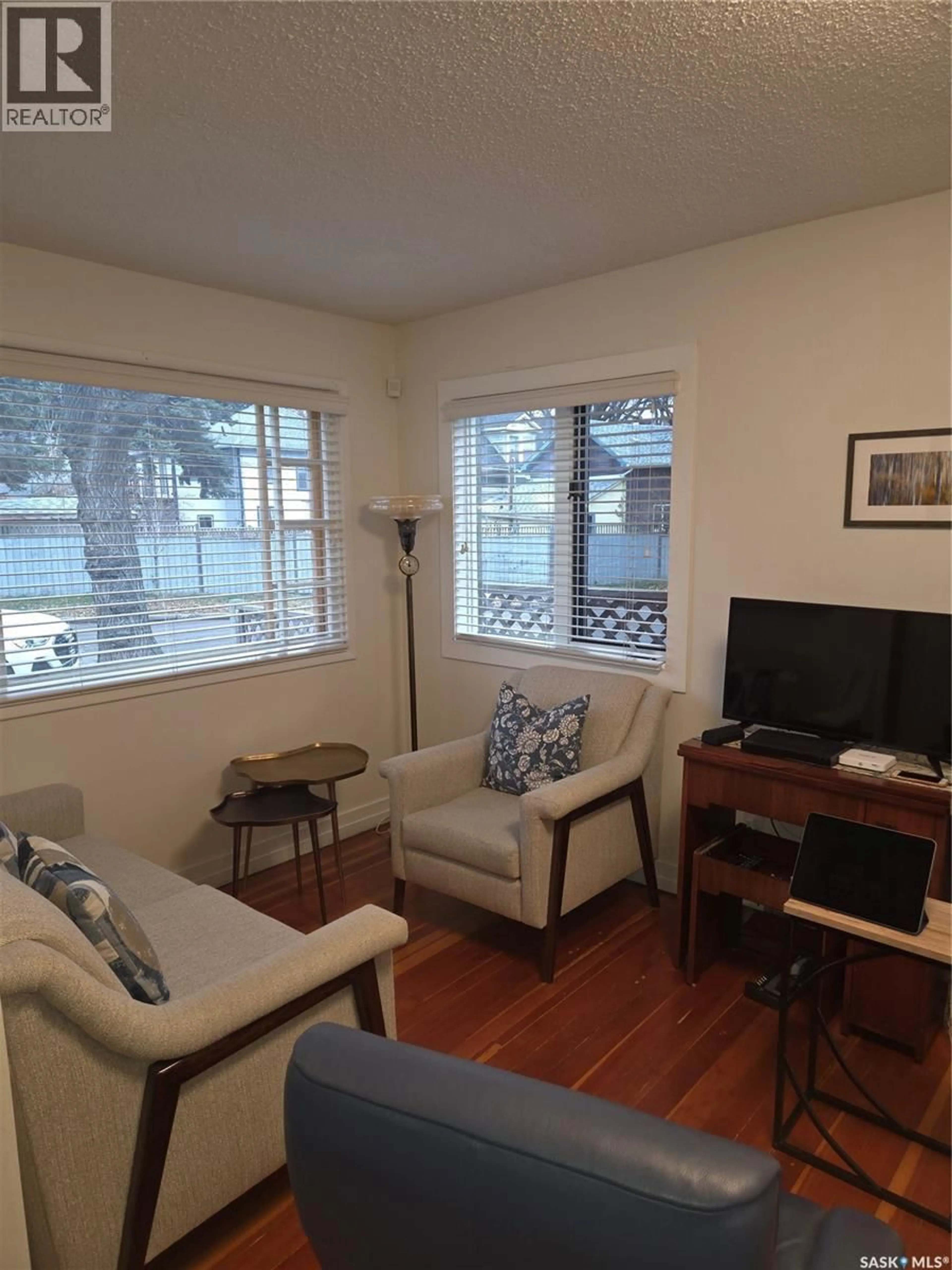 Living room with furniture, wood/laminate floor for 505 F AVENUE, Saskatoon Saskatchewan S7L1W2