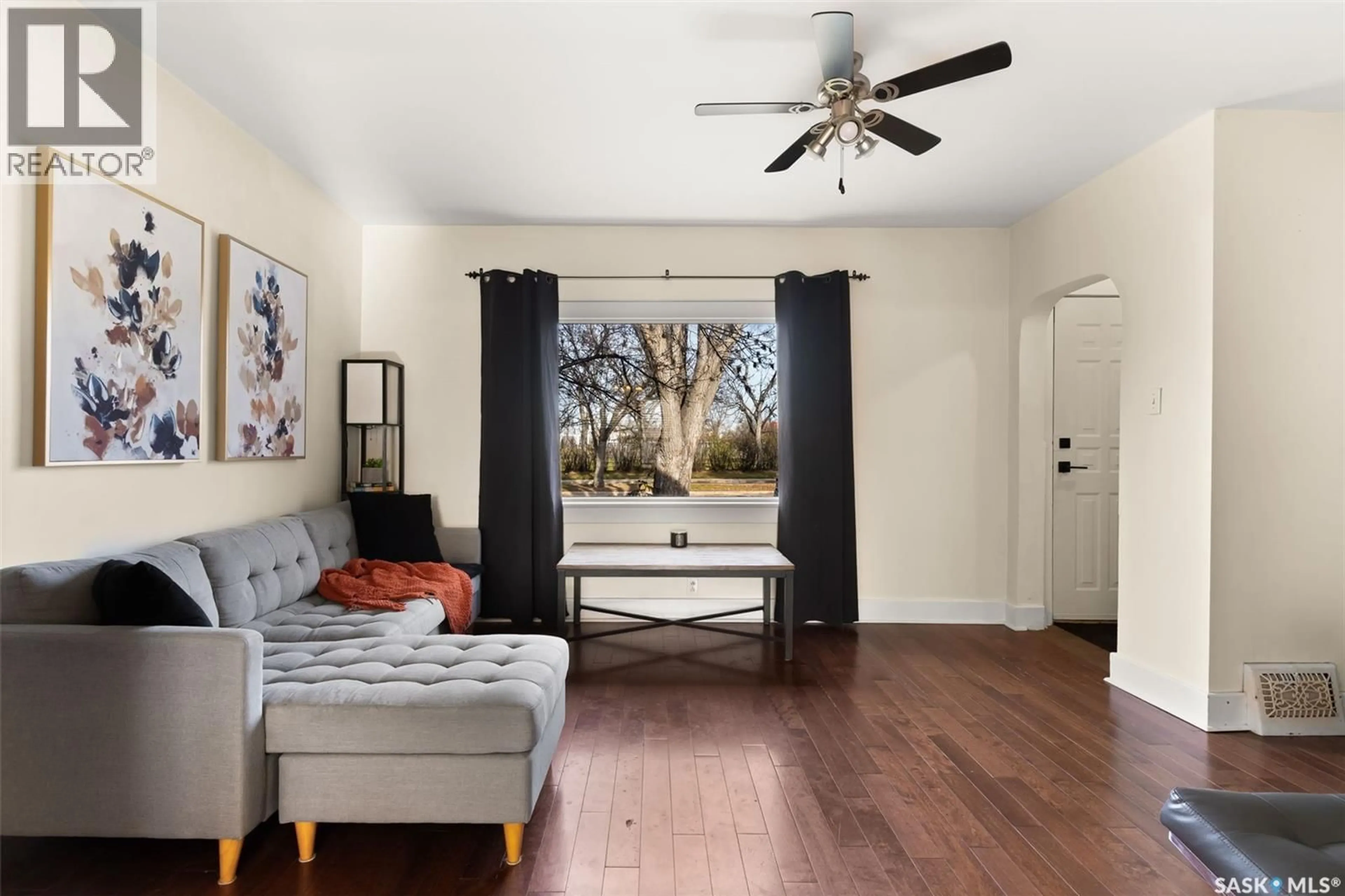 Living room with furniture, wood/laminate floor for 4021 VICTORIA AVENUE, Regina Saskatchewan S4T1M8