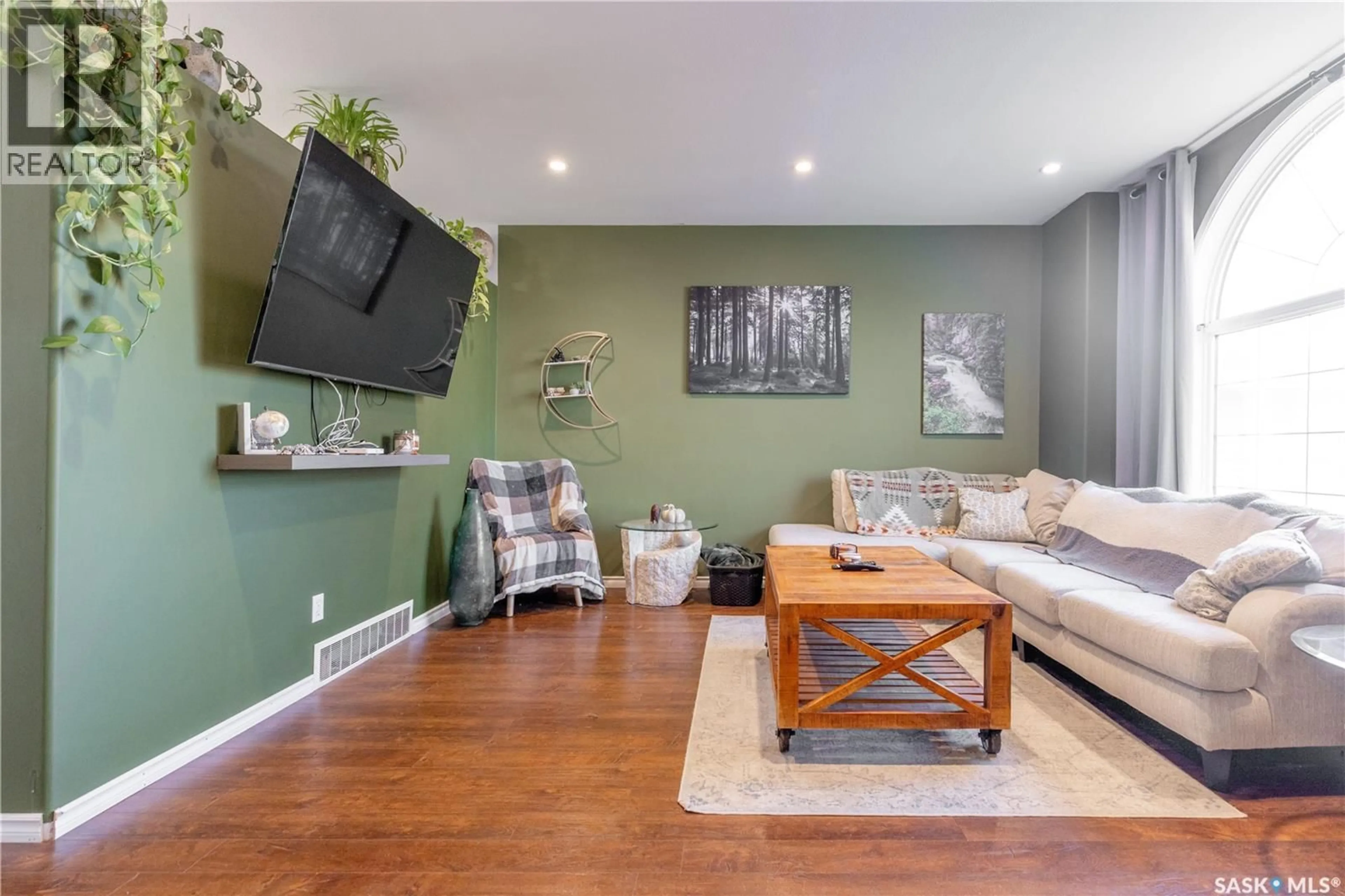 Living room with furniture, wood/laminate floor for 313 VICTOR LANE, Dalmeny Saskatchewan S0K1E0