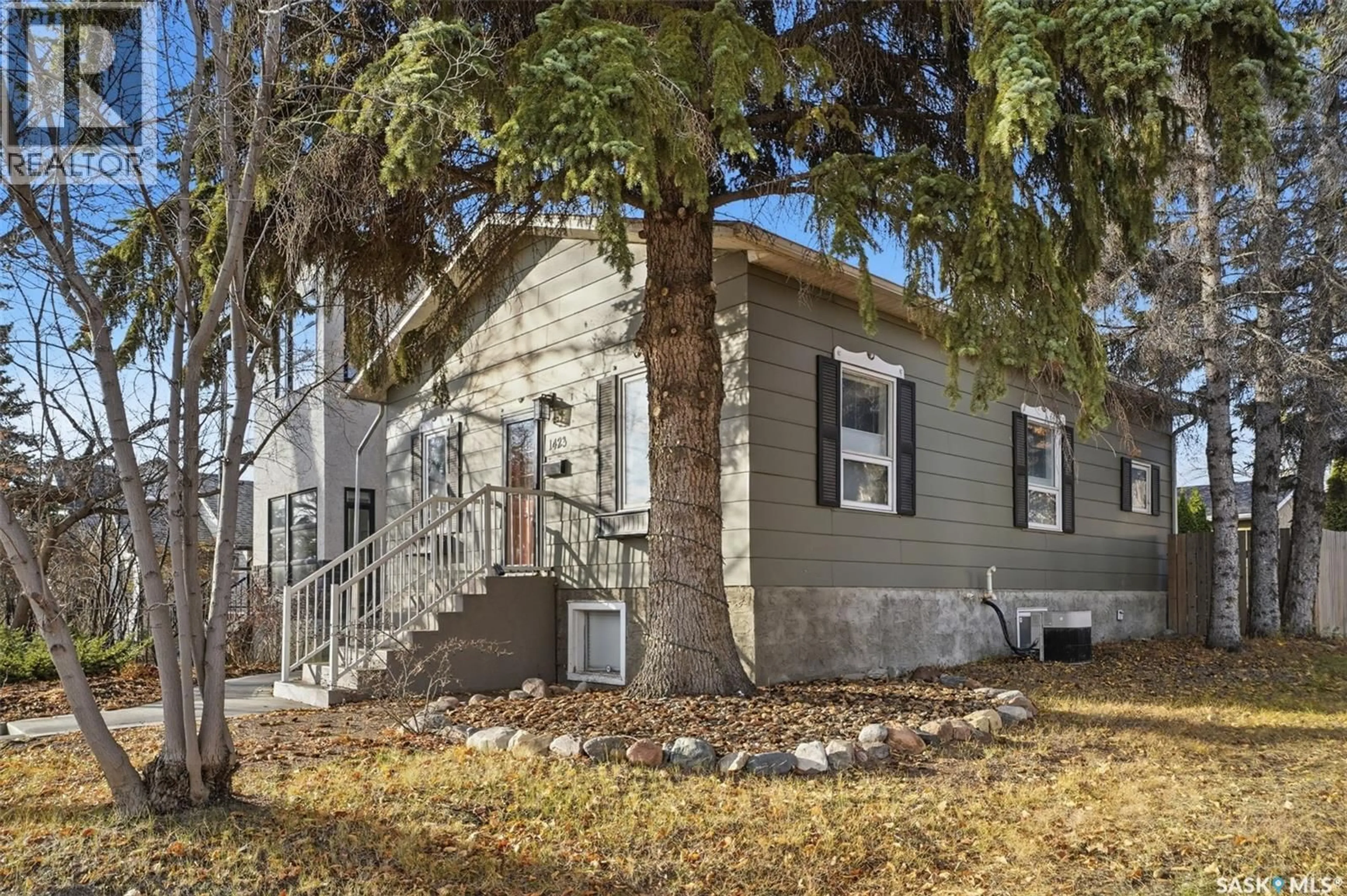 Home with vinyl exterior material, street for 1423 7TH AVENUE, Saskatoon Saskatchewan S7K2W3