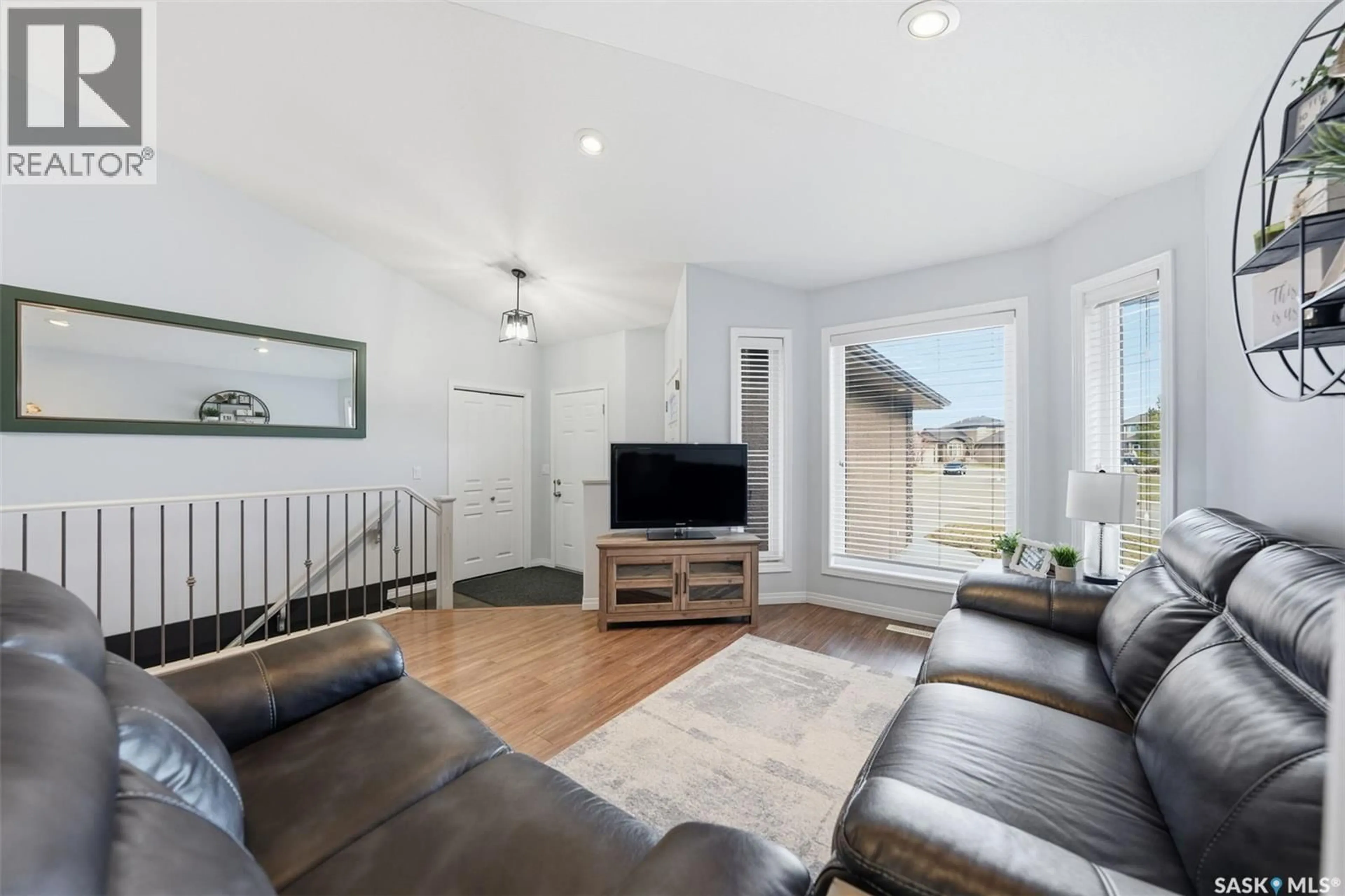 Living room with furniture, wood/laminate floor for 223 REMPEL LANE, Saskatoon Saskatchewan S7T0J3