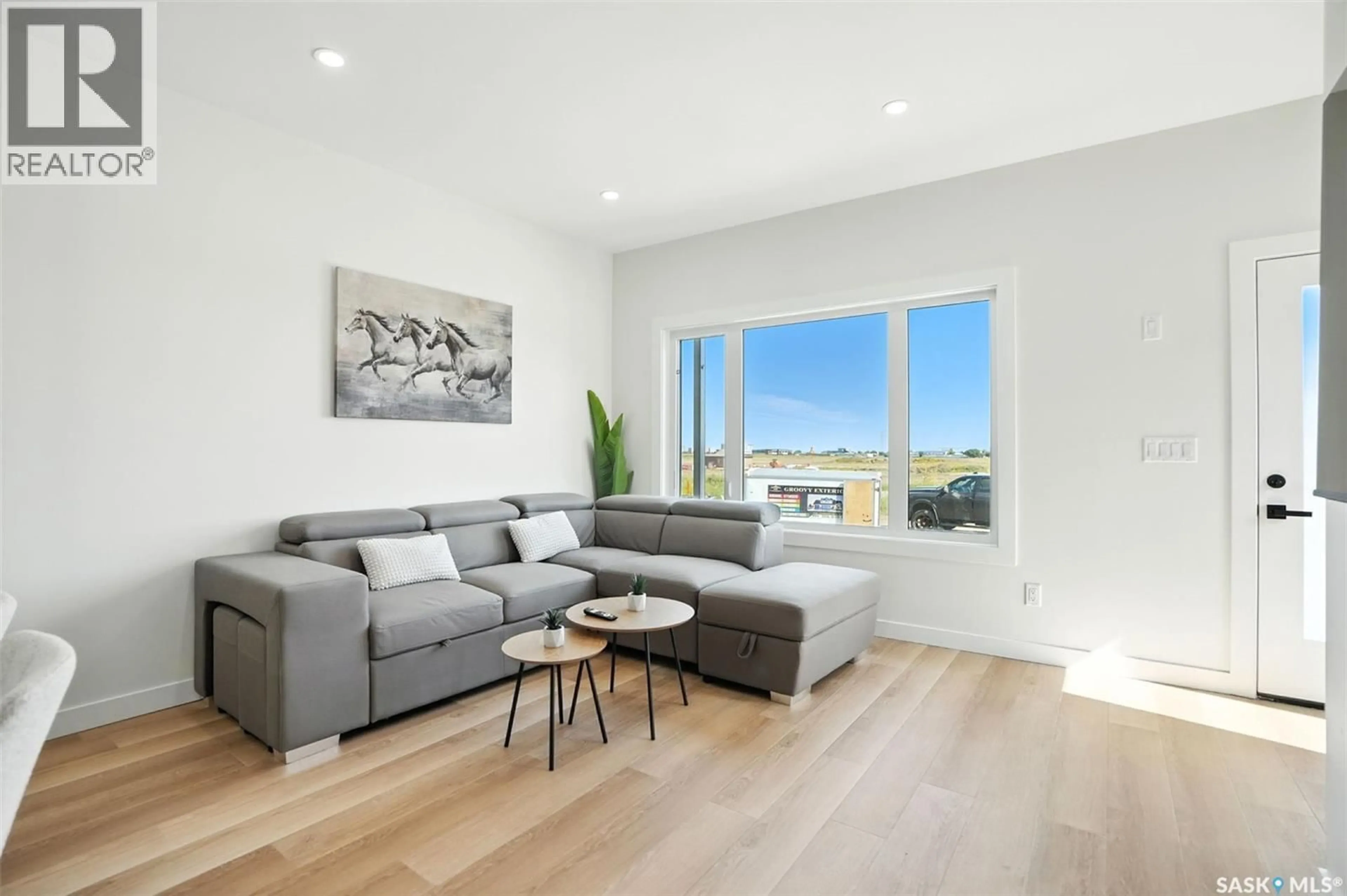 Living room with furniture, wood/laminate floor for 1509 - 163 RICHARDSON ROAD, Saskatoon Saskatchewan S7L4E1