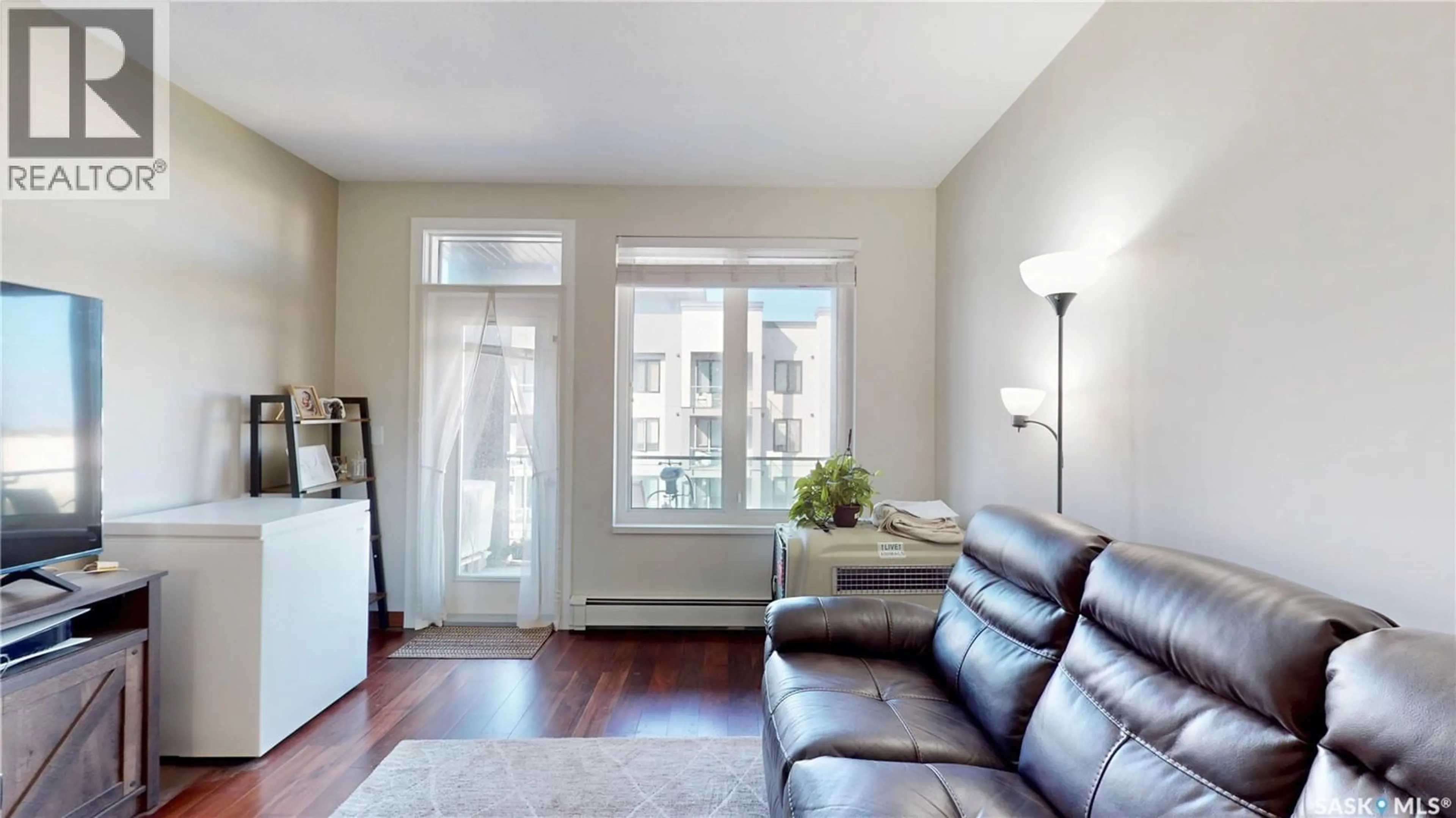 Living room with furniture, wood/laminate floor for 307 - 2165 HESELTINE ROAD, Regina Saskatchewan S4V3P4