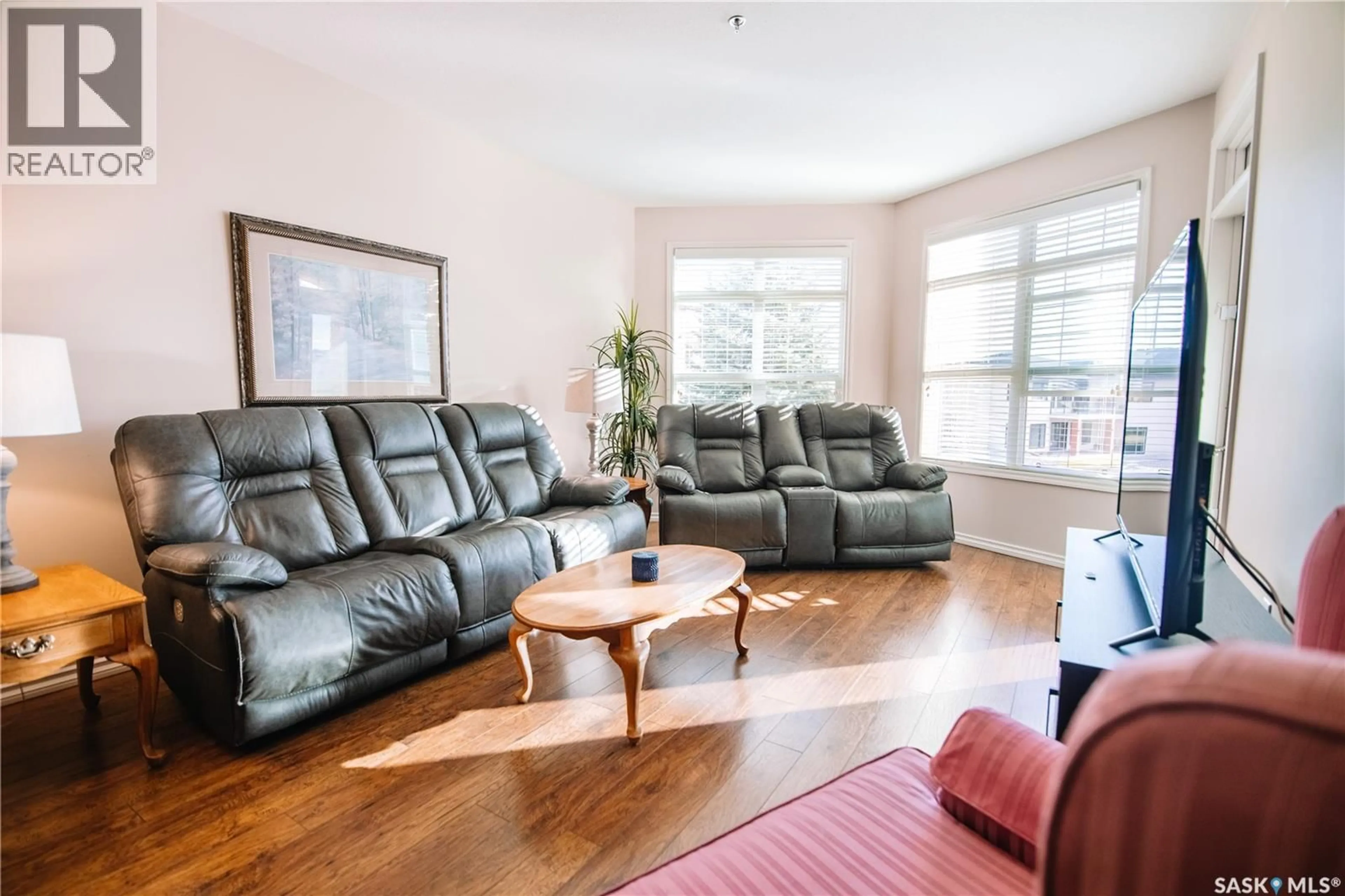 Living room with furniture, wood/laminate floor for 104 2150 HESELTINE ROAD, Regina Saskatchewan S4V1K9