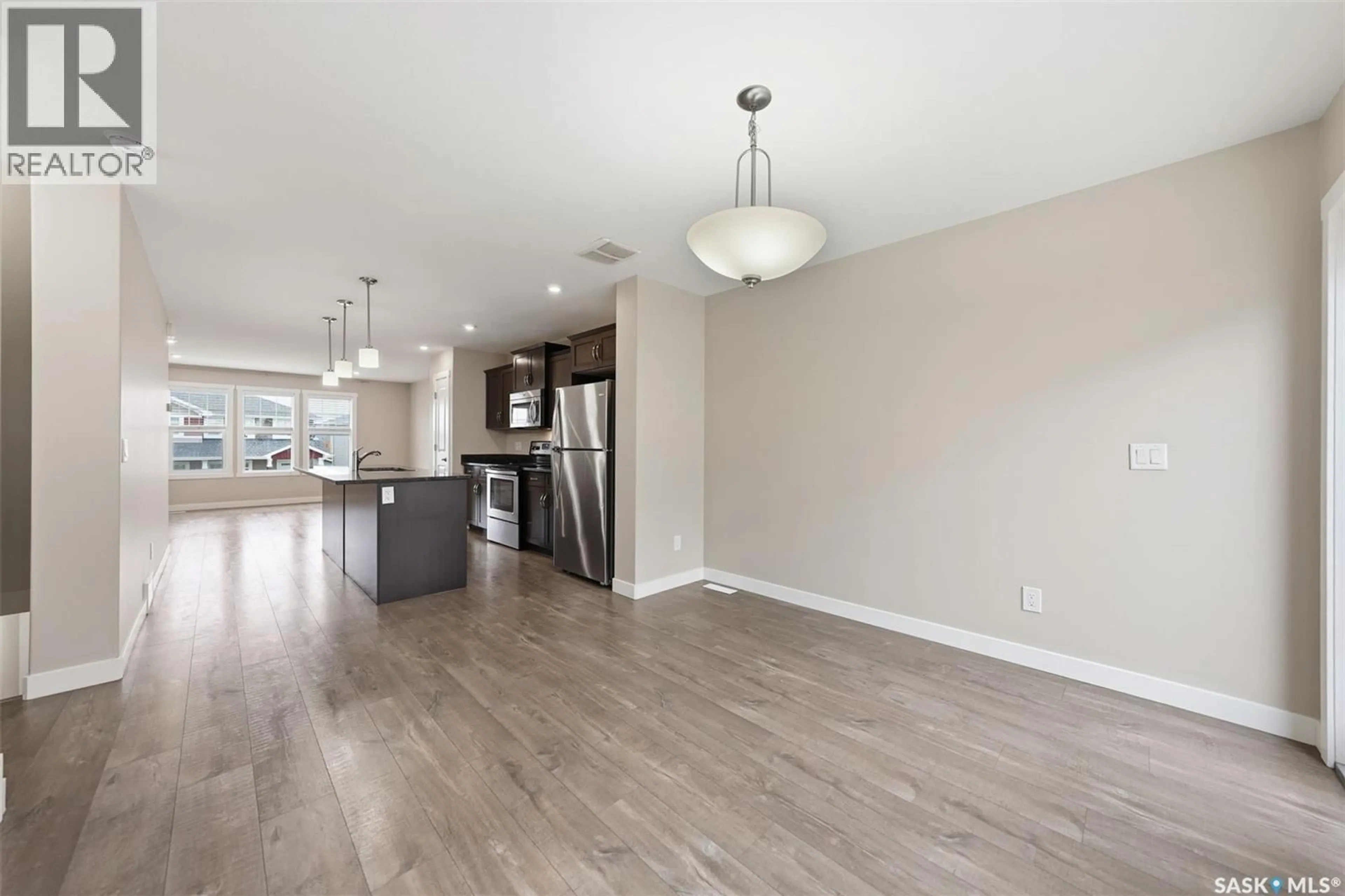 Open concept kitchen, wood/laminate floor for 560 PRINGLE CRESCENT, Saskatoon Saskatchewan S7T0W9