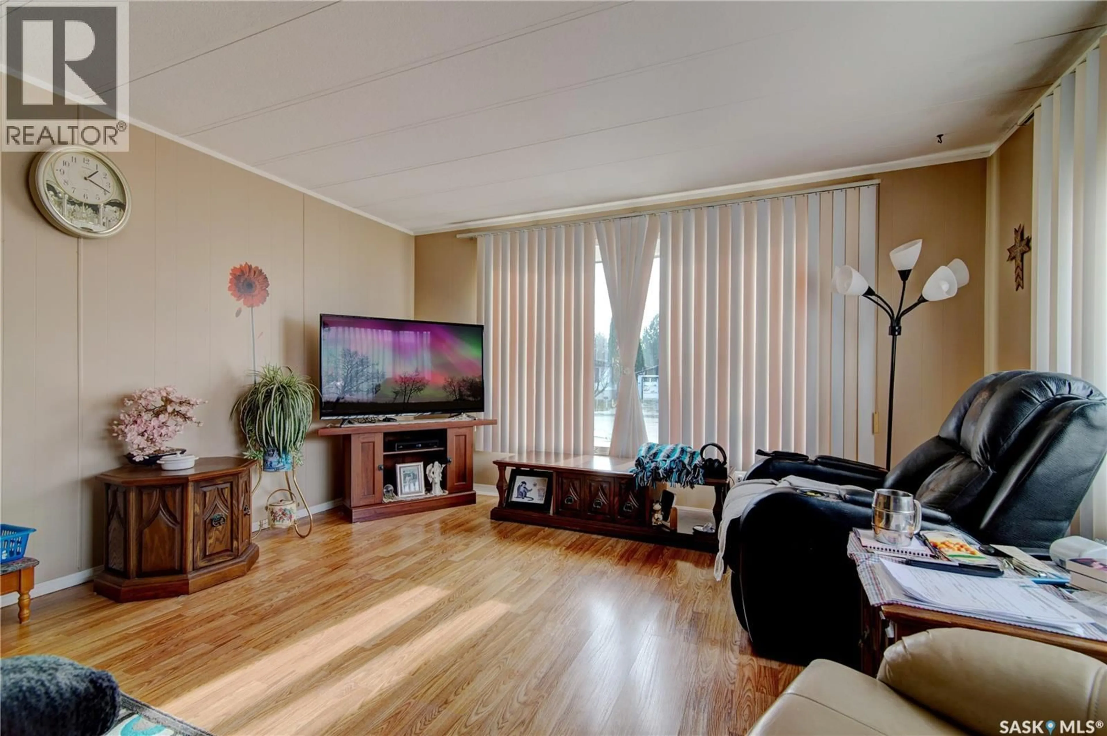 Living room with furniture, wood/laminate floor for 43 GARUIK CRESCENT, Regina Saskatchewan S4R7E5