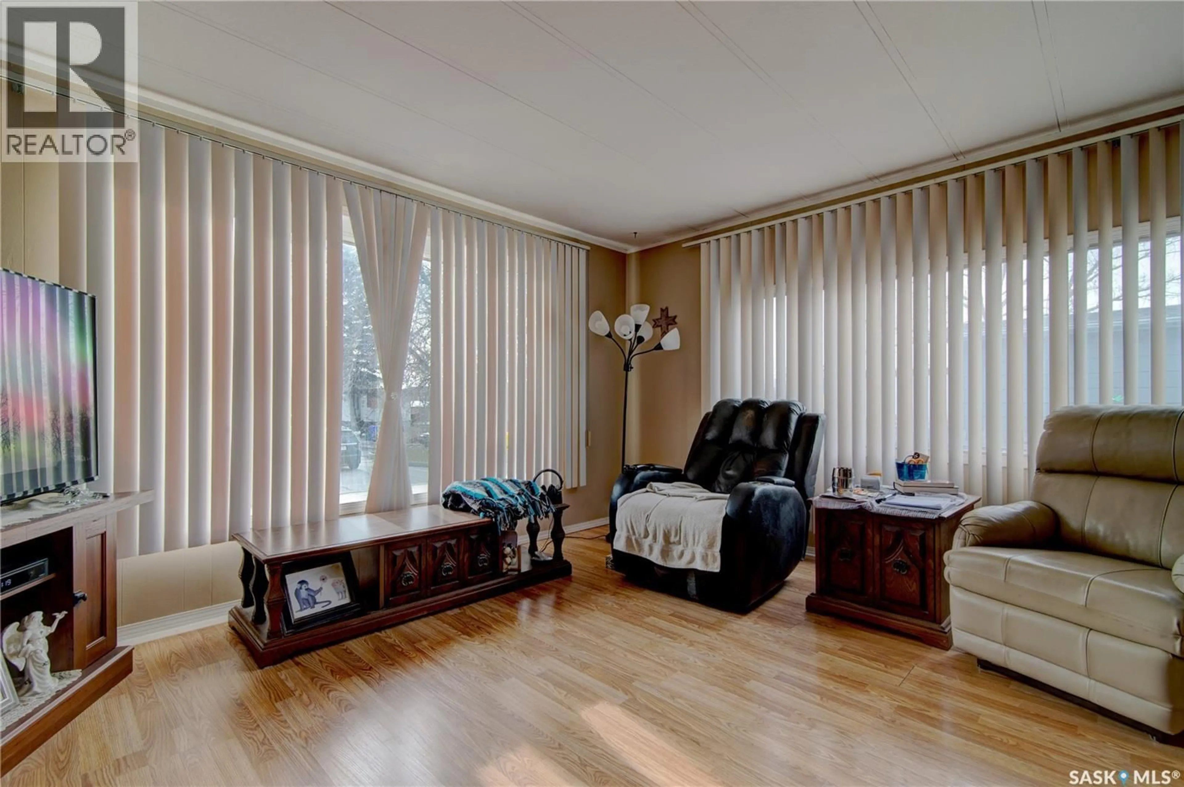 Living room with furniture, wood/laminate floor for 43 GARUIK CRESCENT, Regina Saskatchewan S4R7E5