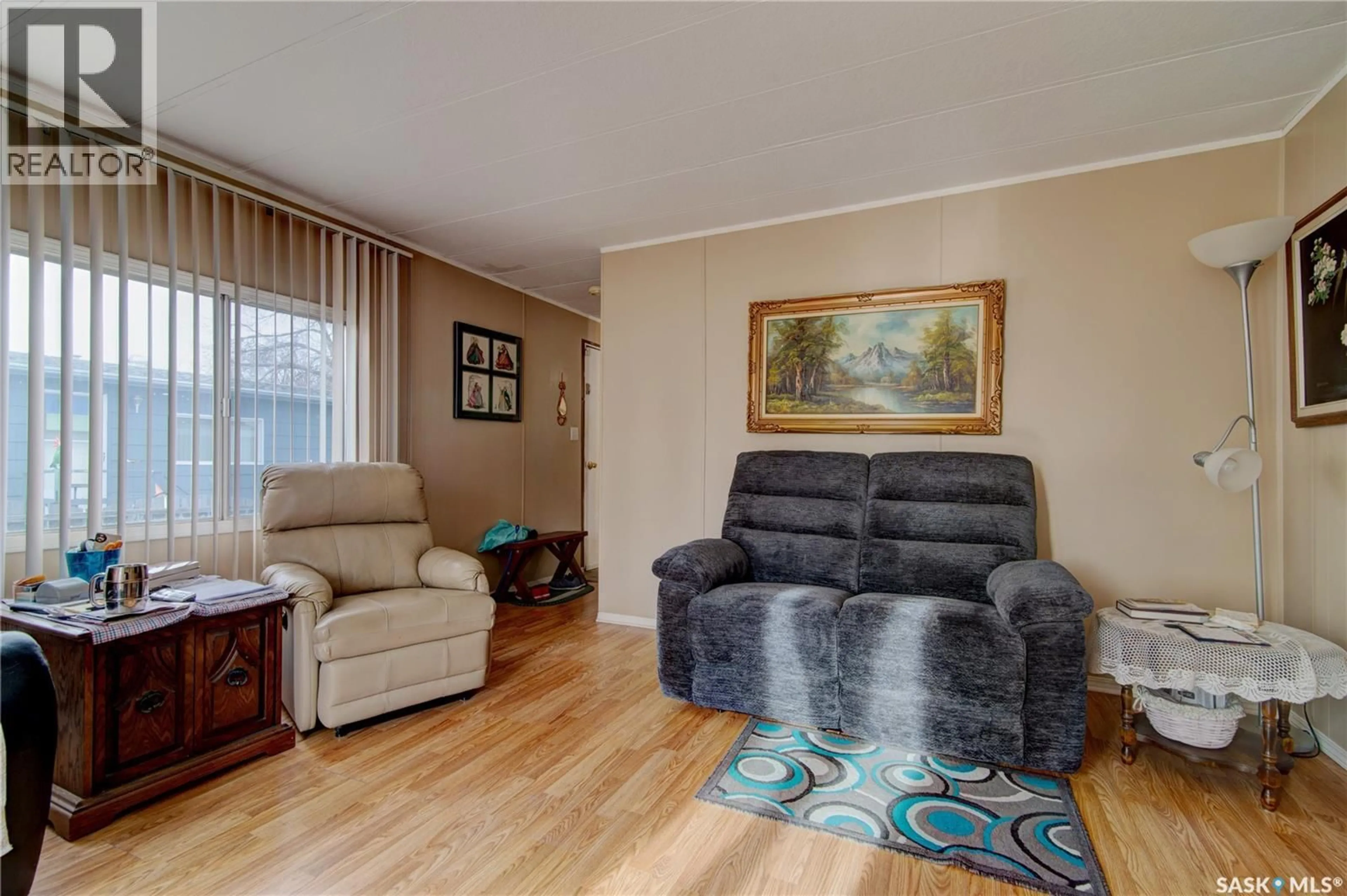 Living room with furniture, wood/laminate floor for 43 GARUIK CRESCENT, Regina Saskatchewan S4R7E5