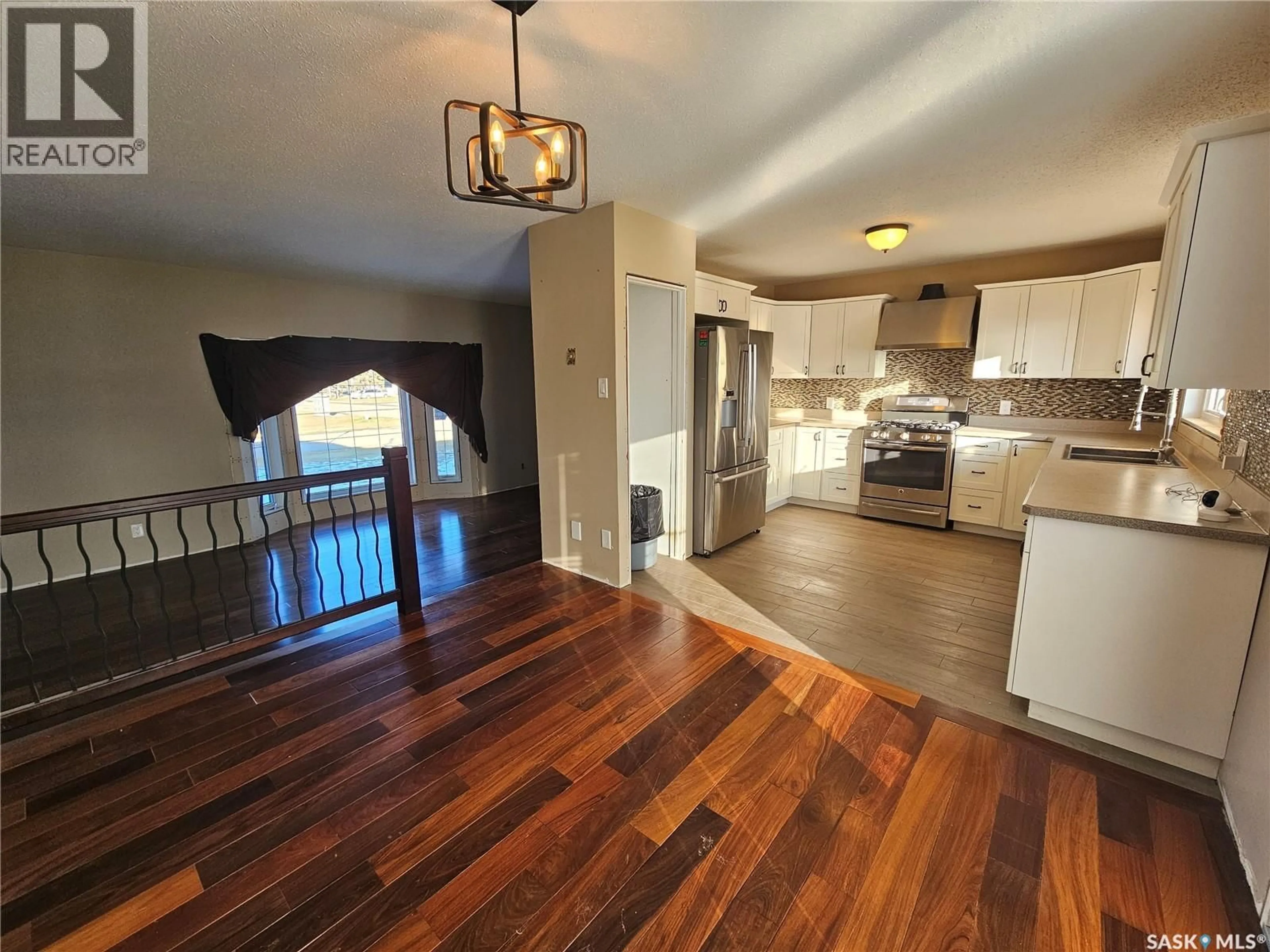 Open concept kitchen, wood/laminate floor for 320 9TH AVENUE, Meadow Lake Saskatchewan S9X1H1