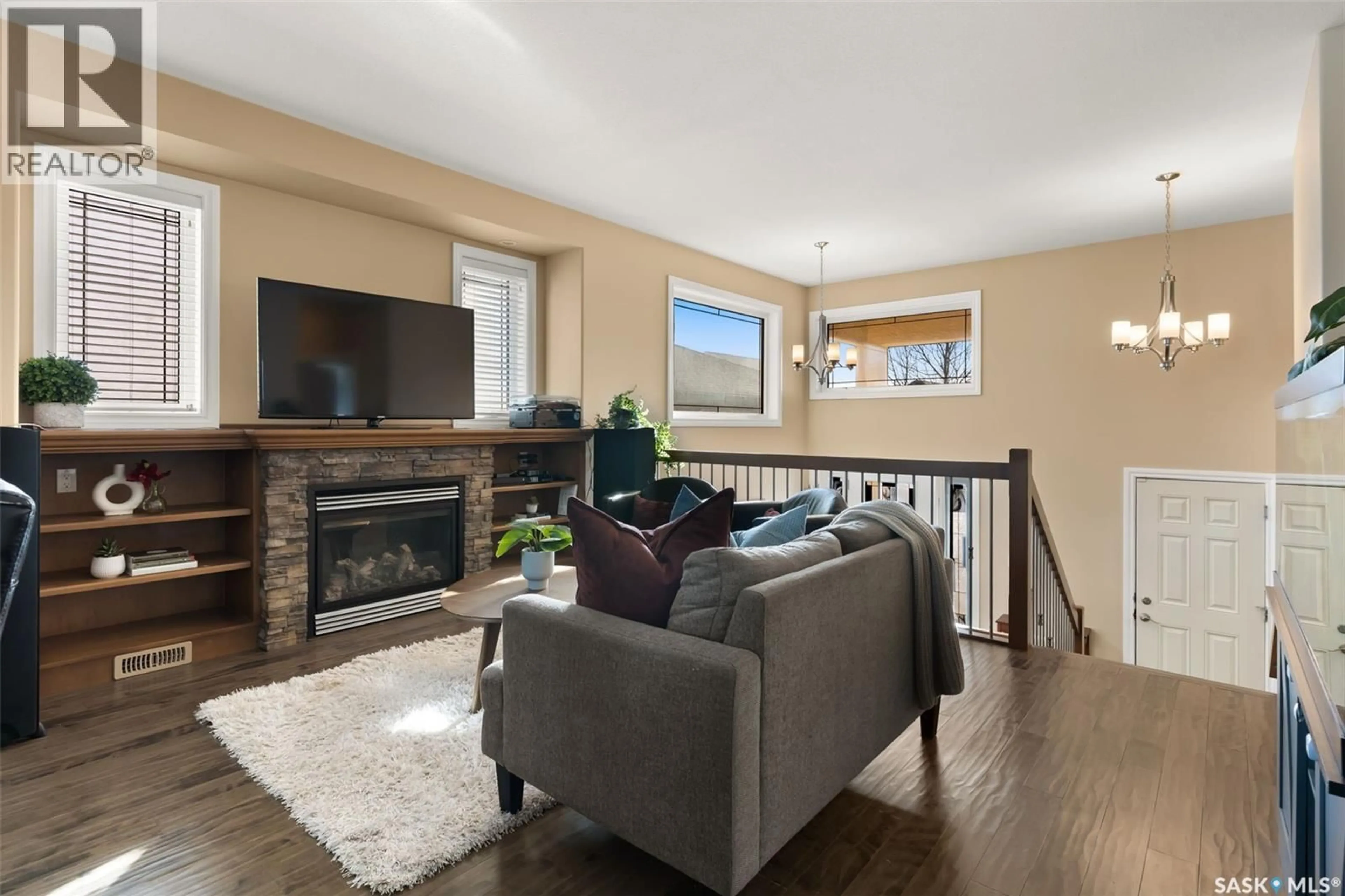 Living room with furniture, wood/laminate floor for 5241 AERIAL CRESCENT, Regina Saskatchewan S4W0C8