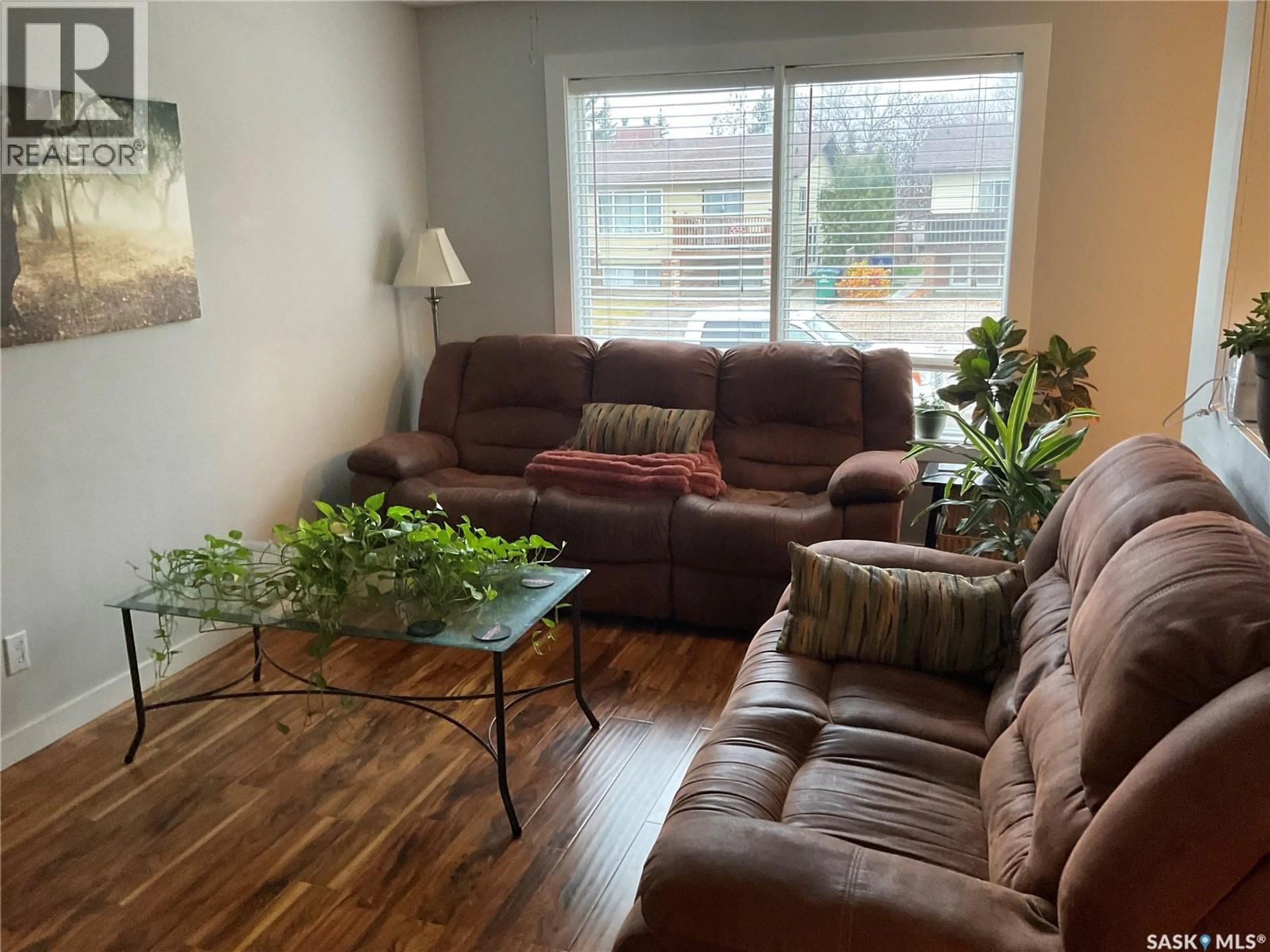 Living room with furniture, wood/laminate floor for 1613 - 1611 LAURA AVENUE, Saskatoon Saskatchewan S7N2T2