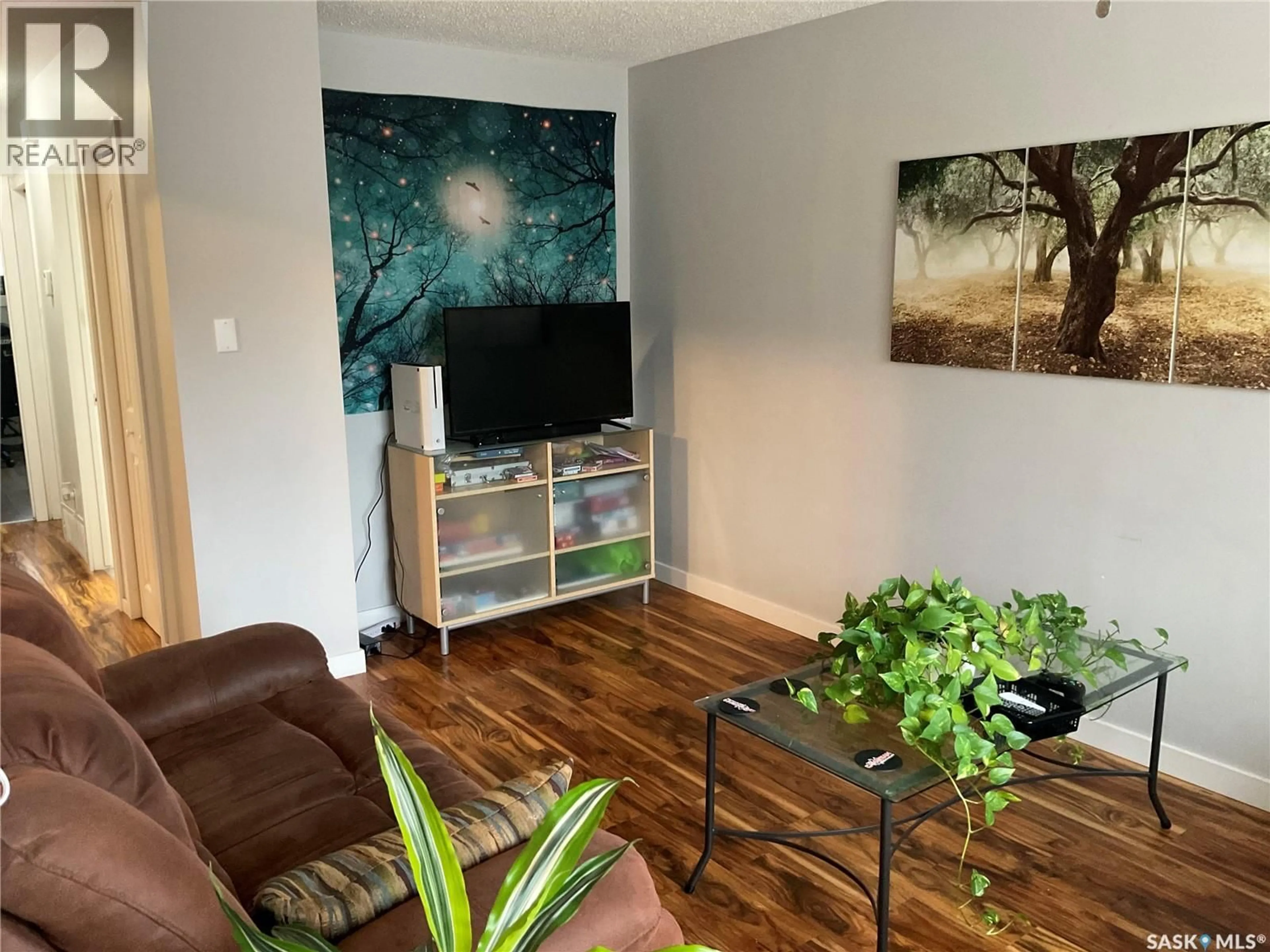 Living room with furniture, wood/laminate floor for 1613 - 1611 LAURA AVENUE, Saskatoon Saskatchewan S7N2T2