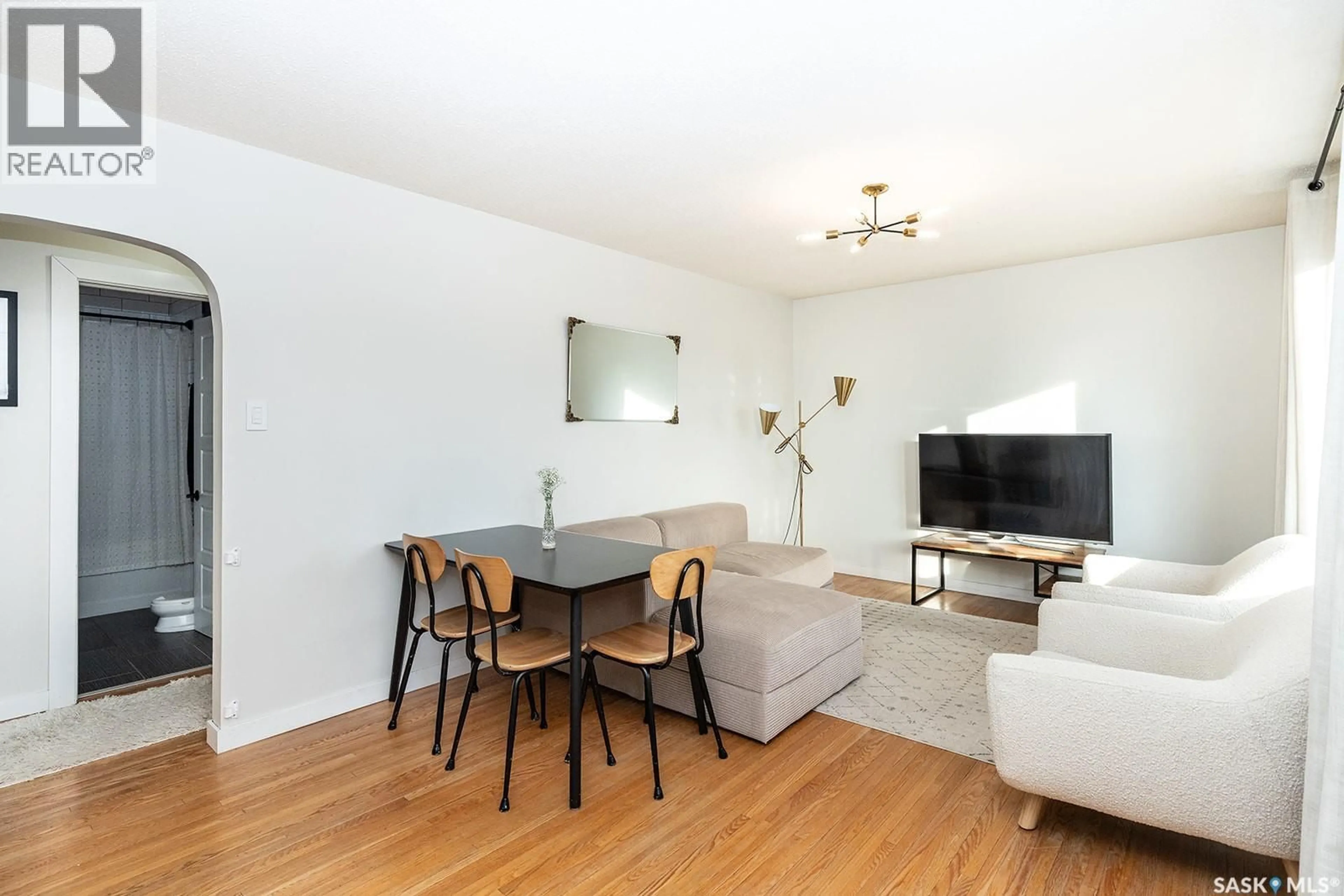 Living room with furniture, wood/laminate floor for 2212 YORK AVENUE, Saskatoon Saskatchewan S7J1J1