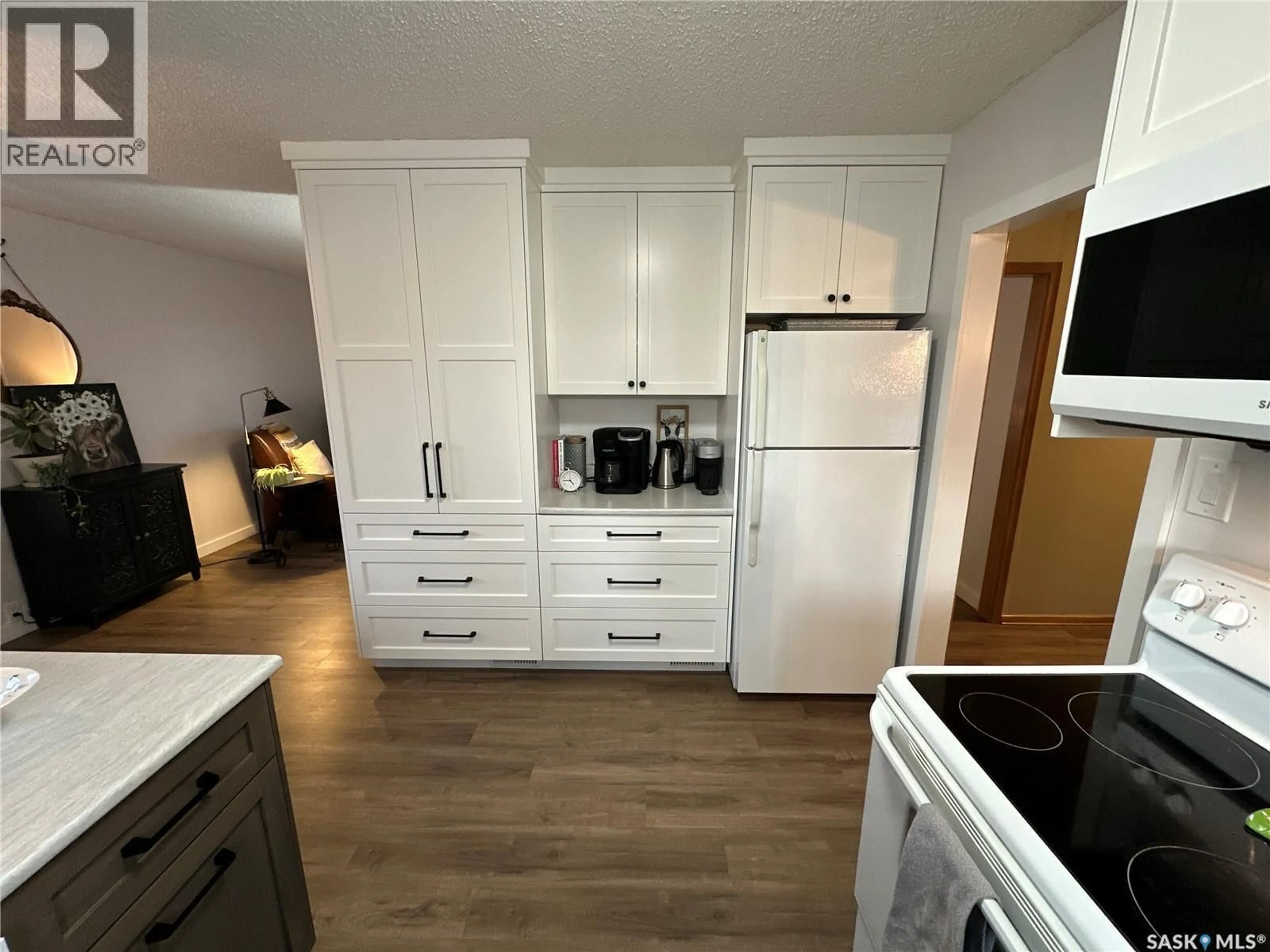 Open concept kitchen, wood/laminate floor for 1019 8TH STREET, Rosthern Saskatchewan S0K3R0