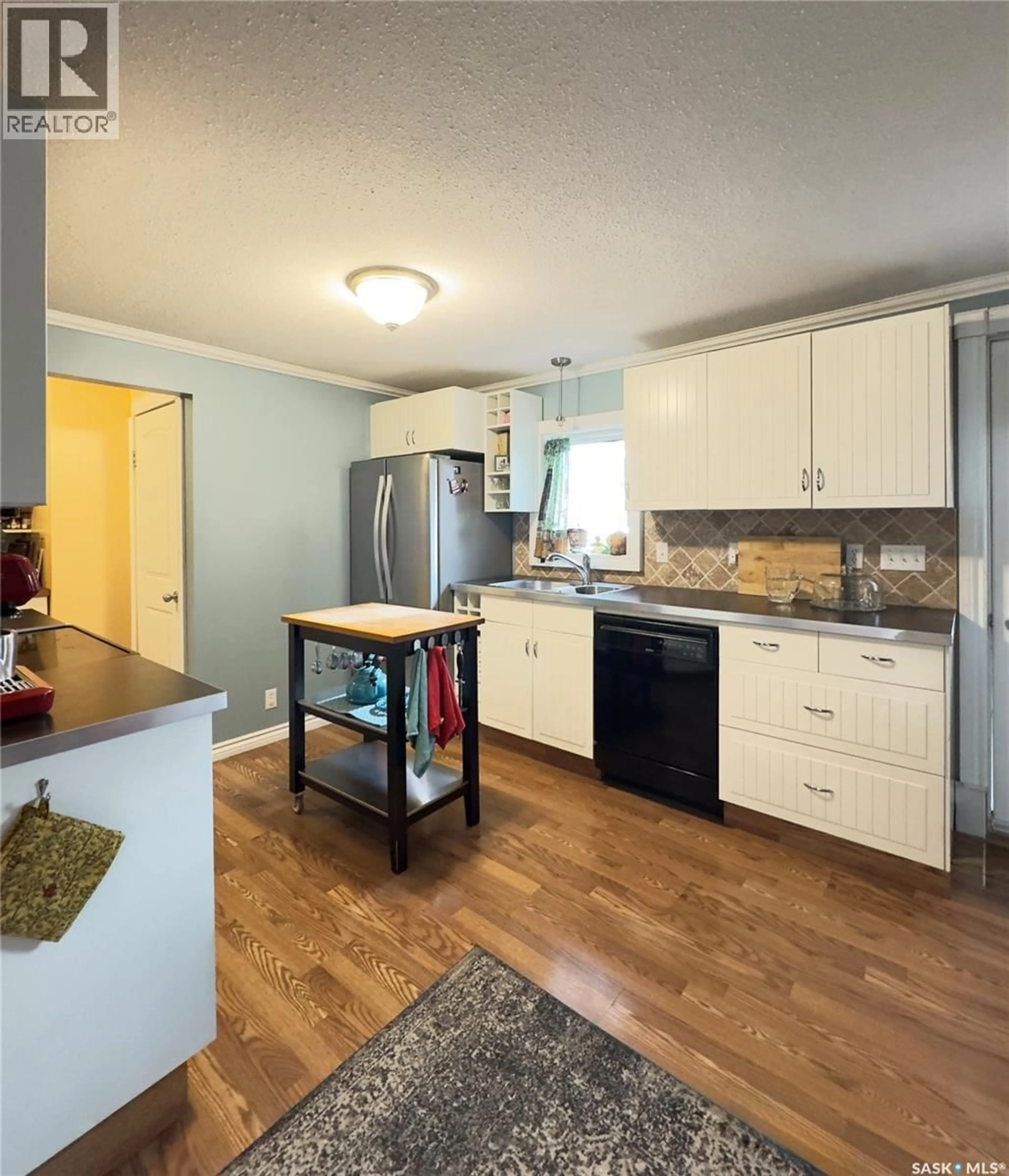 Open concept kitchen, wood/laminate floor for 109 1ST STREET, Waldheim Saskatchewan S0K4R0