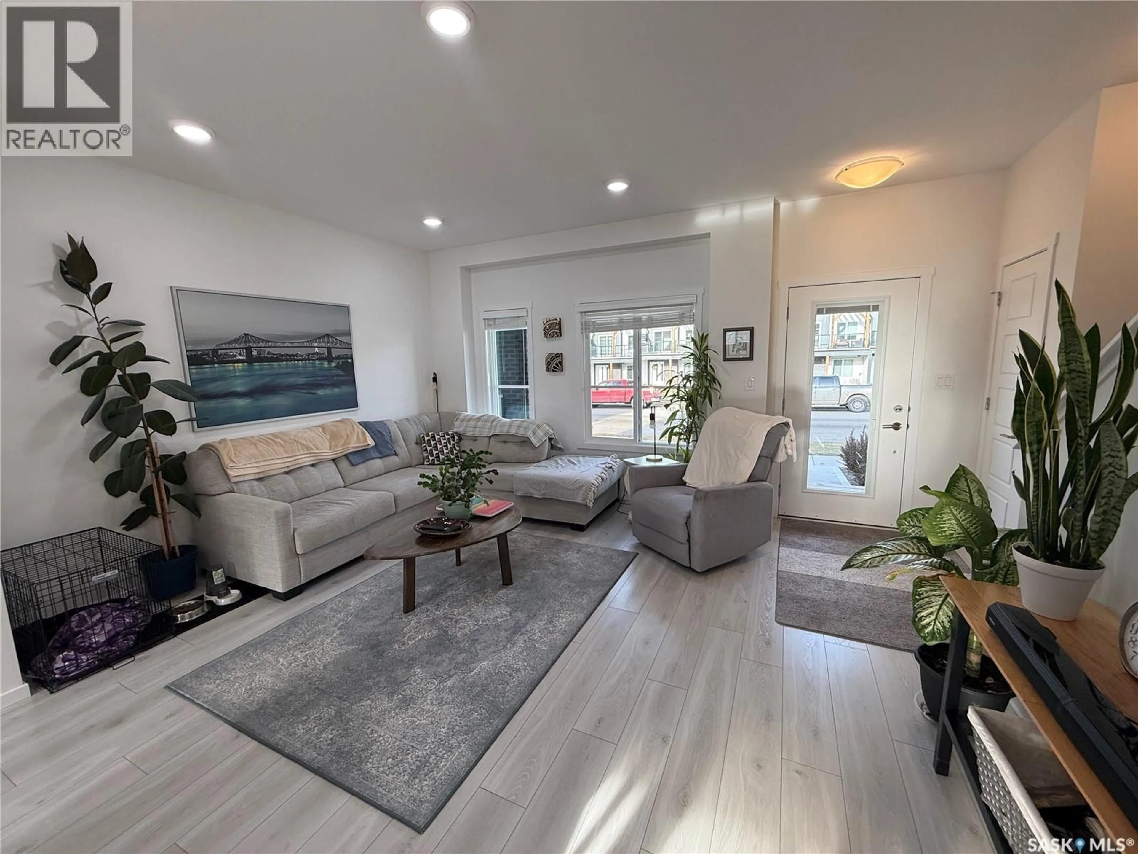 Living room with furniture, wood/laminate floor for 4226 BRIGHTON CIRCLE, Saskatoon Saskatchewan S7V0N5