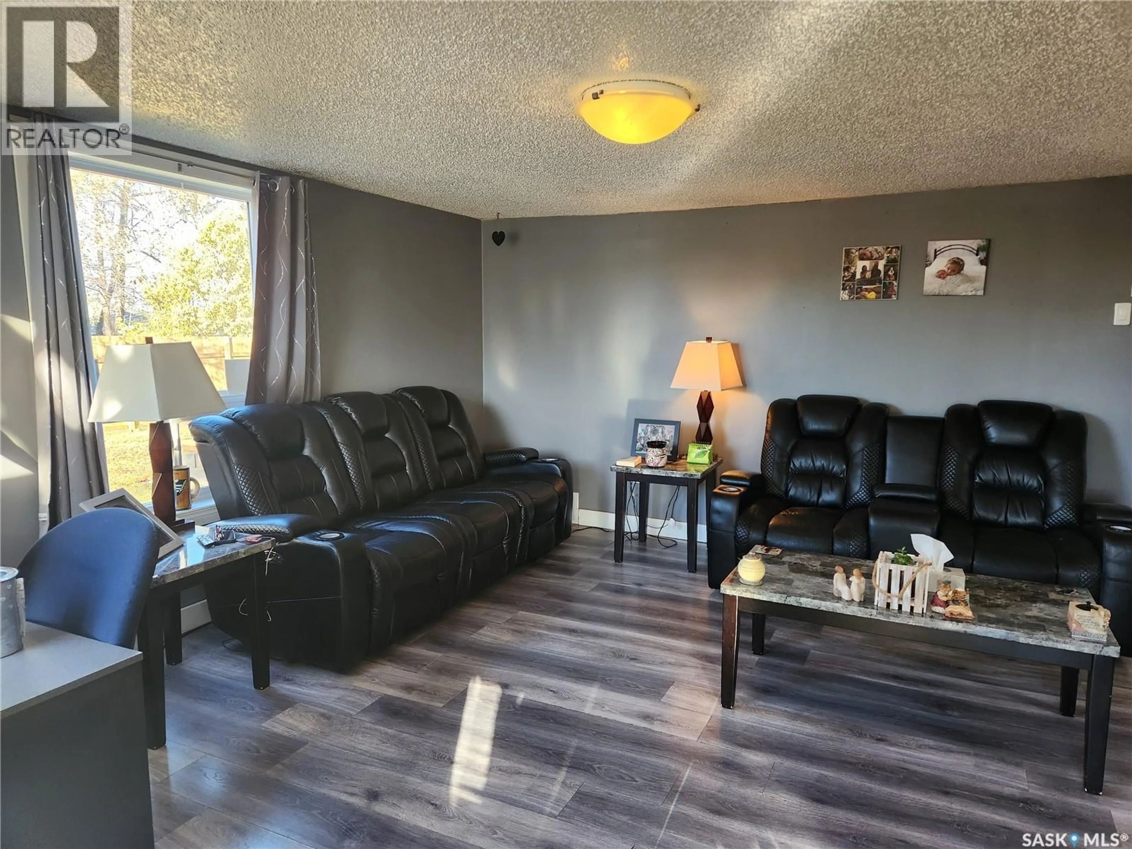 Living room with furniture, wood/laminate floor for 309 4TH STREET, Nipawin Saskatchewan S0E1E0