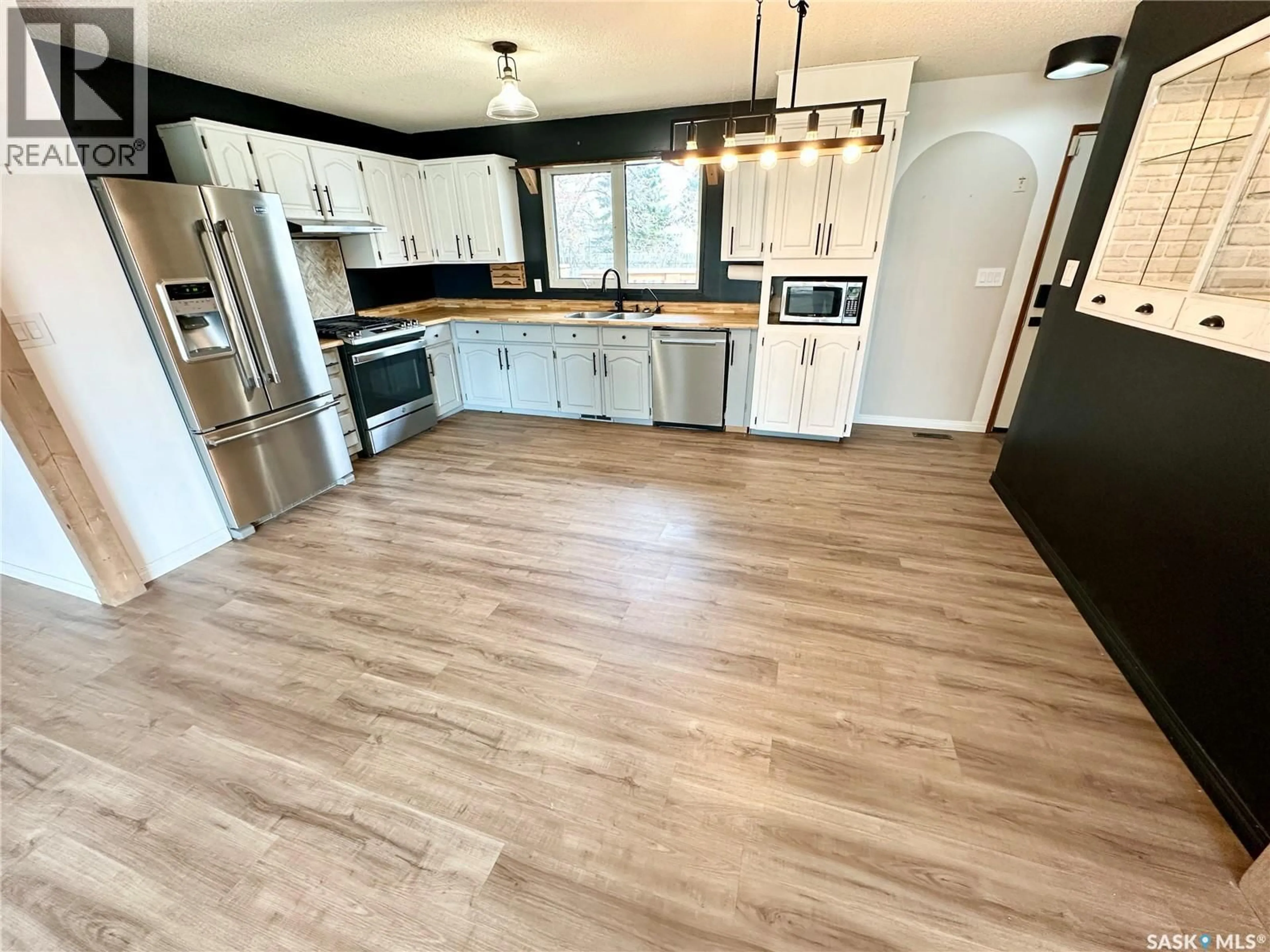 Open concept kitchen, wood/laminate floor for 224 17TH STREET, Weyburn Saskatchewan S4H2P2