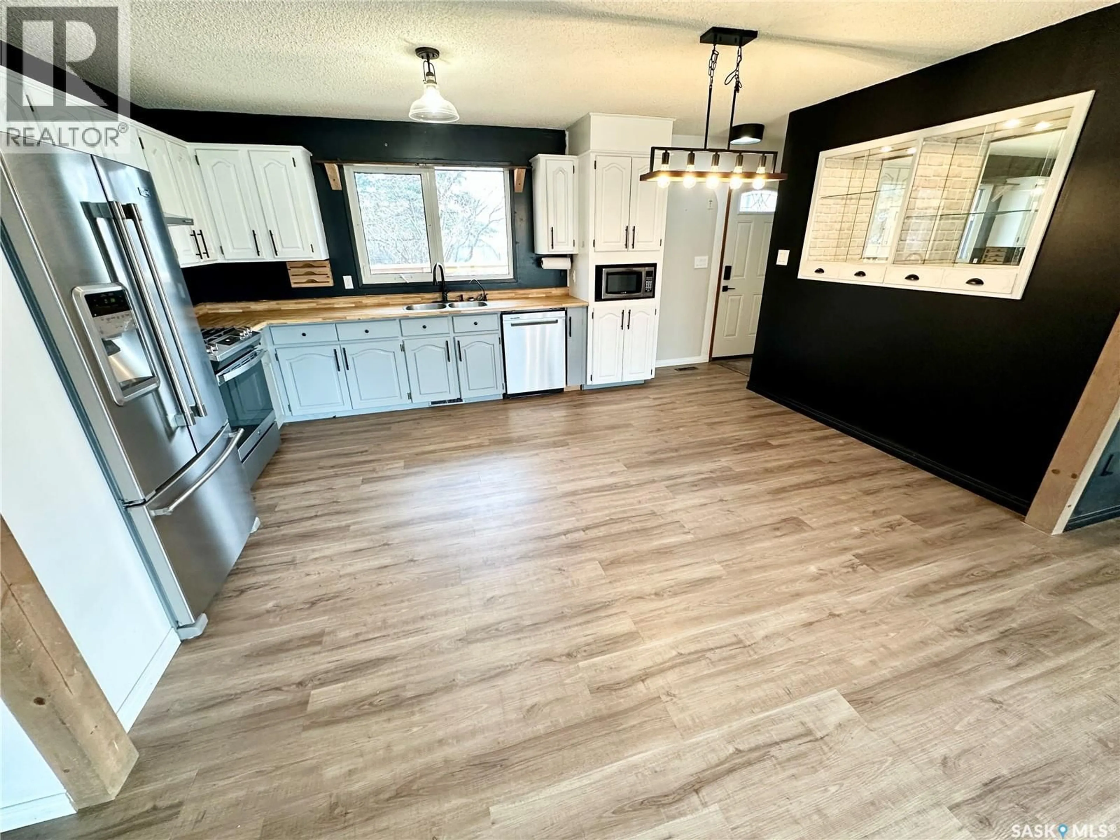 Open concept kitchen, wood/laminate floor for 224 17TH STREET, Weyburn Saskatchewan S4H2P2