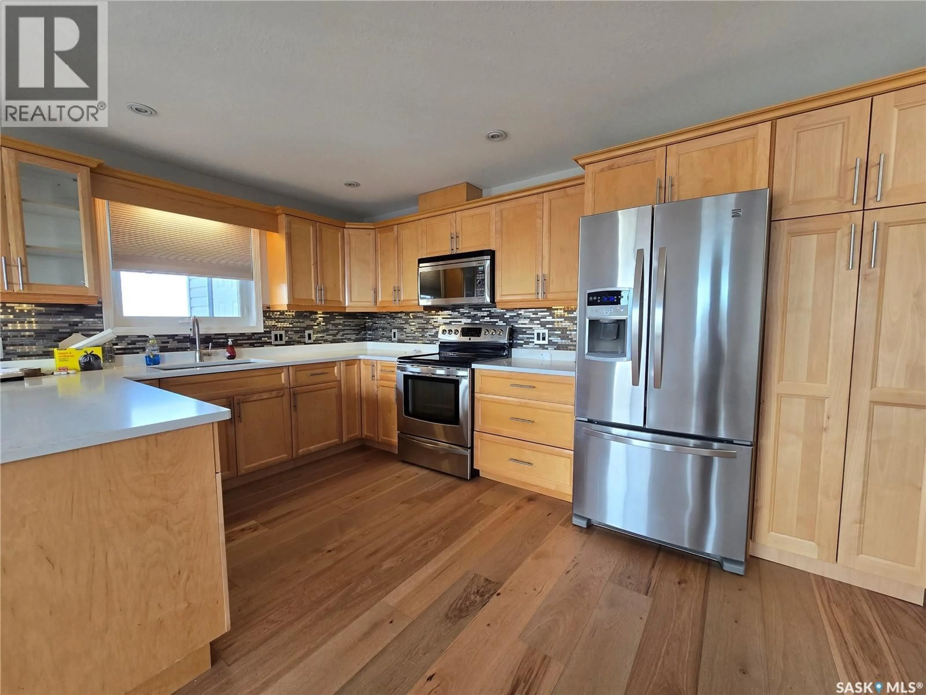 Open concept kitchen, wood/laminate floor for 505 - 407 BANNERMAN STREET, Weyburn Saskatchewan S4H1V5