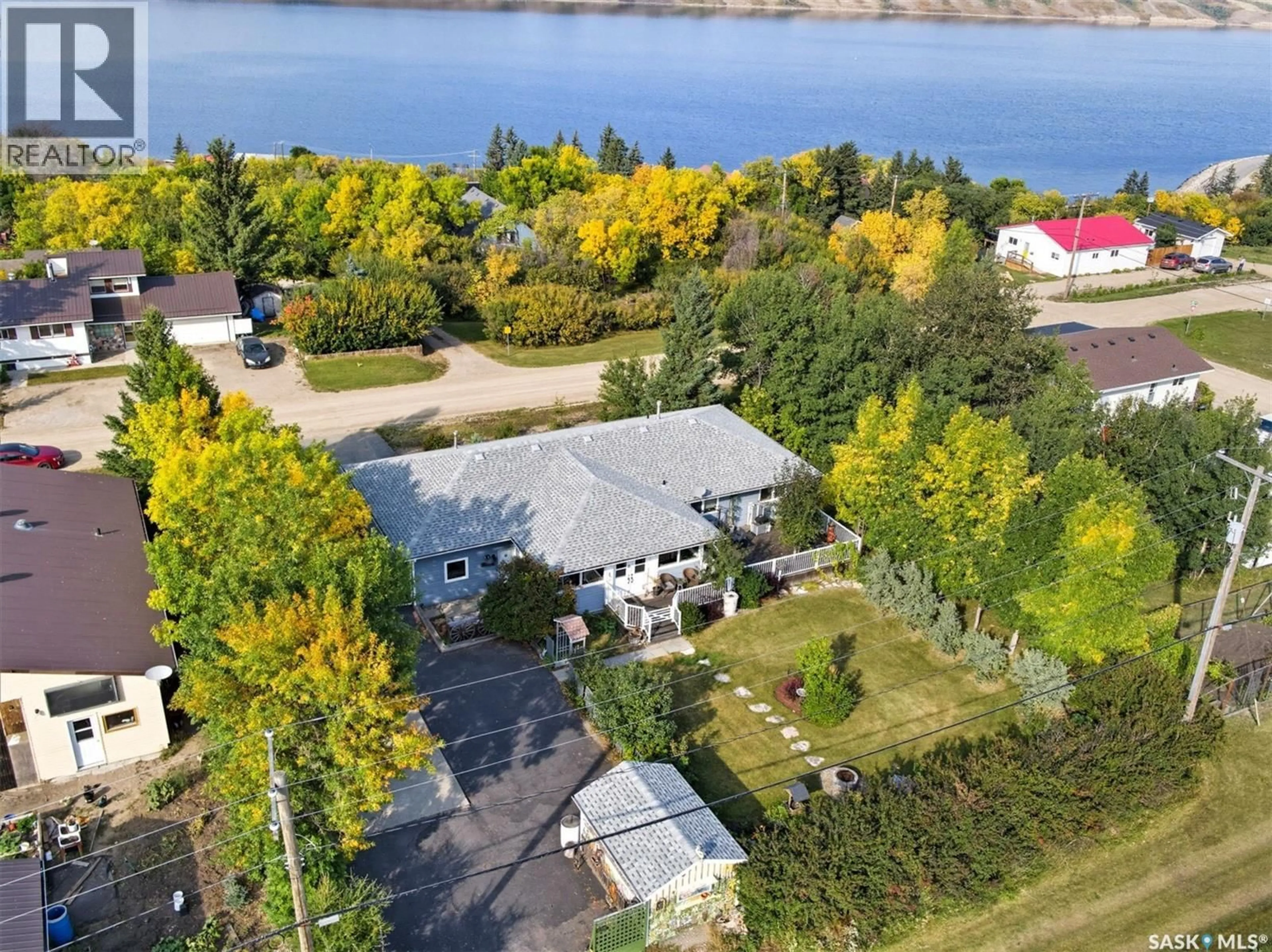 A pic from outside/outdoor area/front of a property/back of a property/a pic from drone, water/lake/river/ocean view for 104-108 LAKEVIEW AVENUE, Manitou Beach Saskatchewan S0K4T1