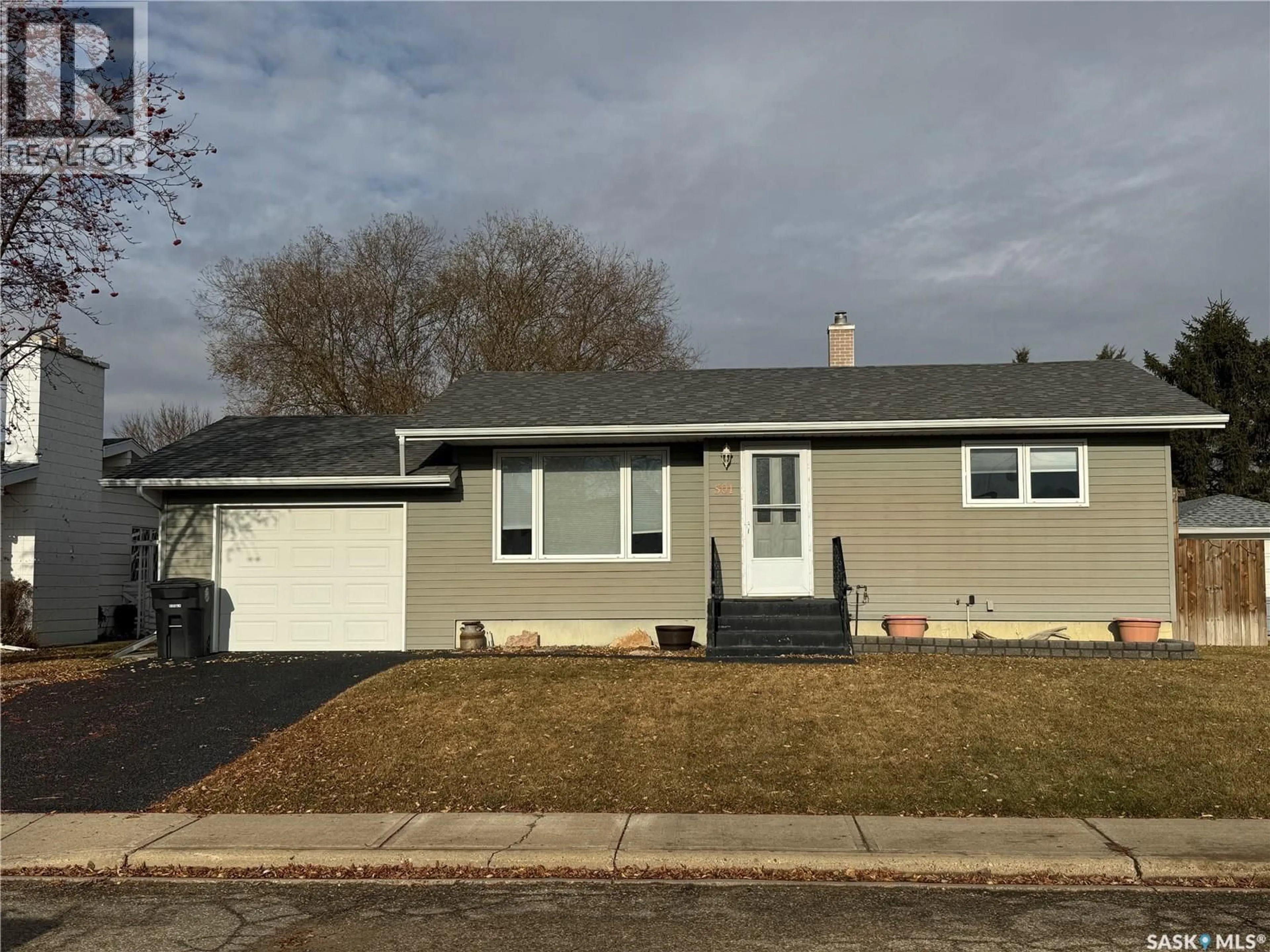 Home with vinyl exterior material, street for 501 7TH AVENUE, Biggar Saskatchewan S0K0M0