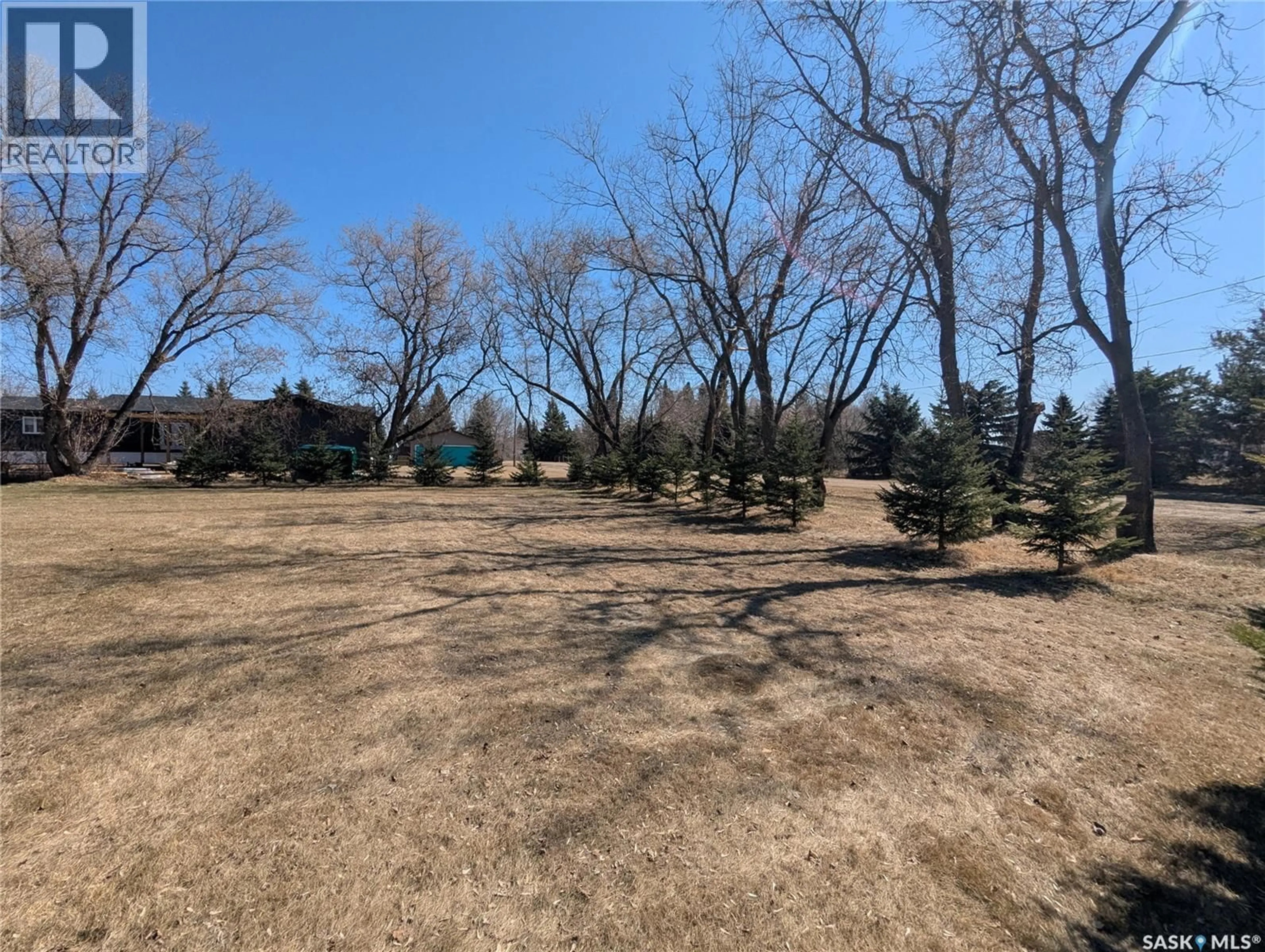 A pic from outside/outdoor area/front of a property/back of a property/a pic from drone, forest/trees view for 129 LEMIEUX CRESCENT, Leoville Saskatchewan S0J1N0