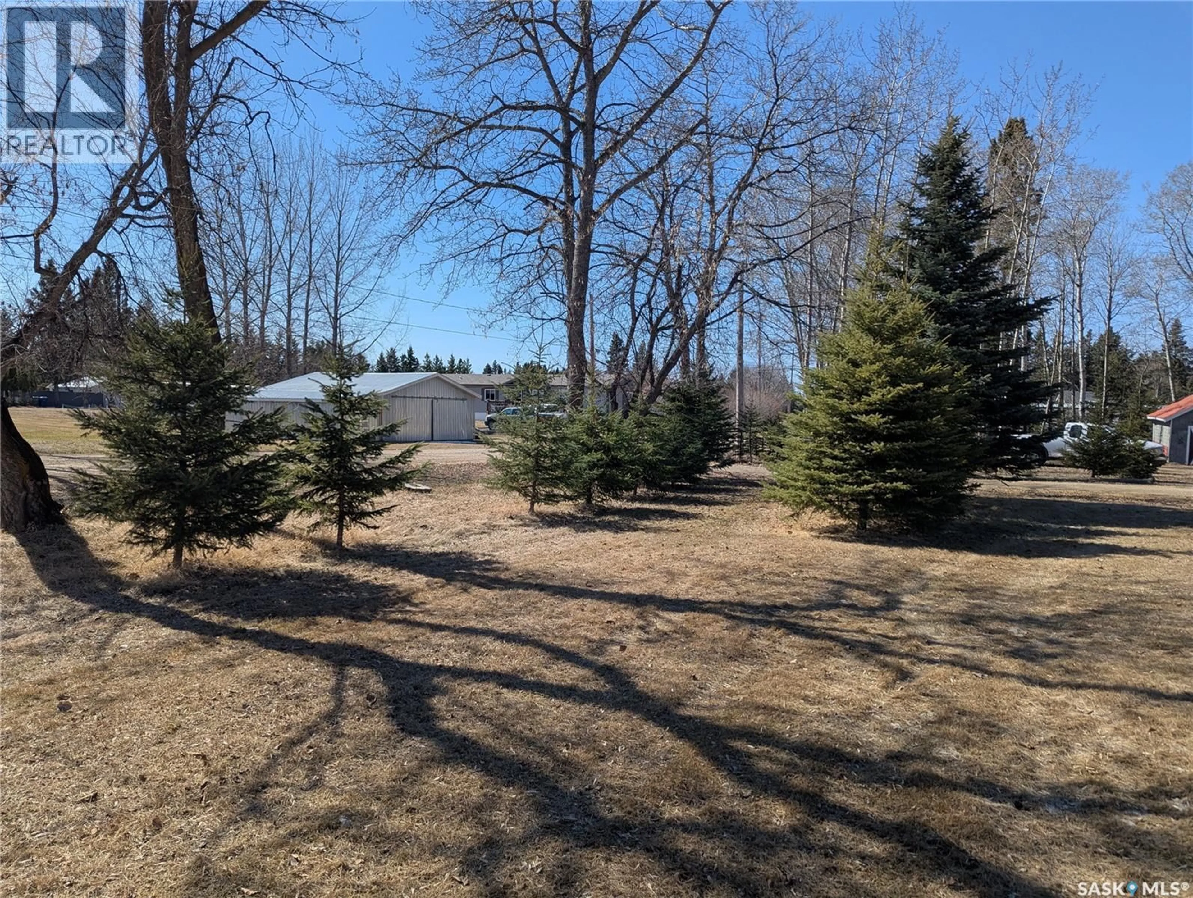 A pic from outside/outdoor area/front of a property/back of a property/a pic from drone, forest/trees view for 129 LEMIEUX CRESCENT, Leoville Saskatchewan S0J1N0