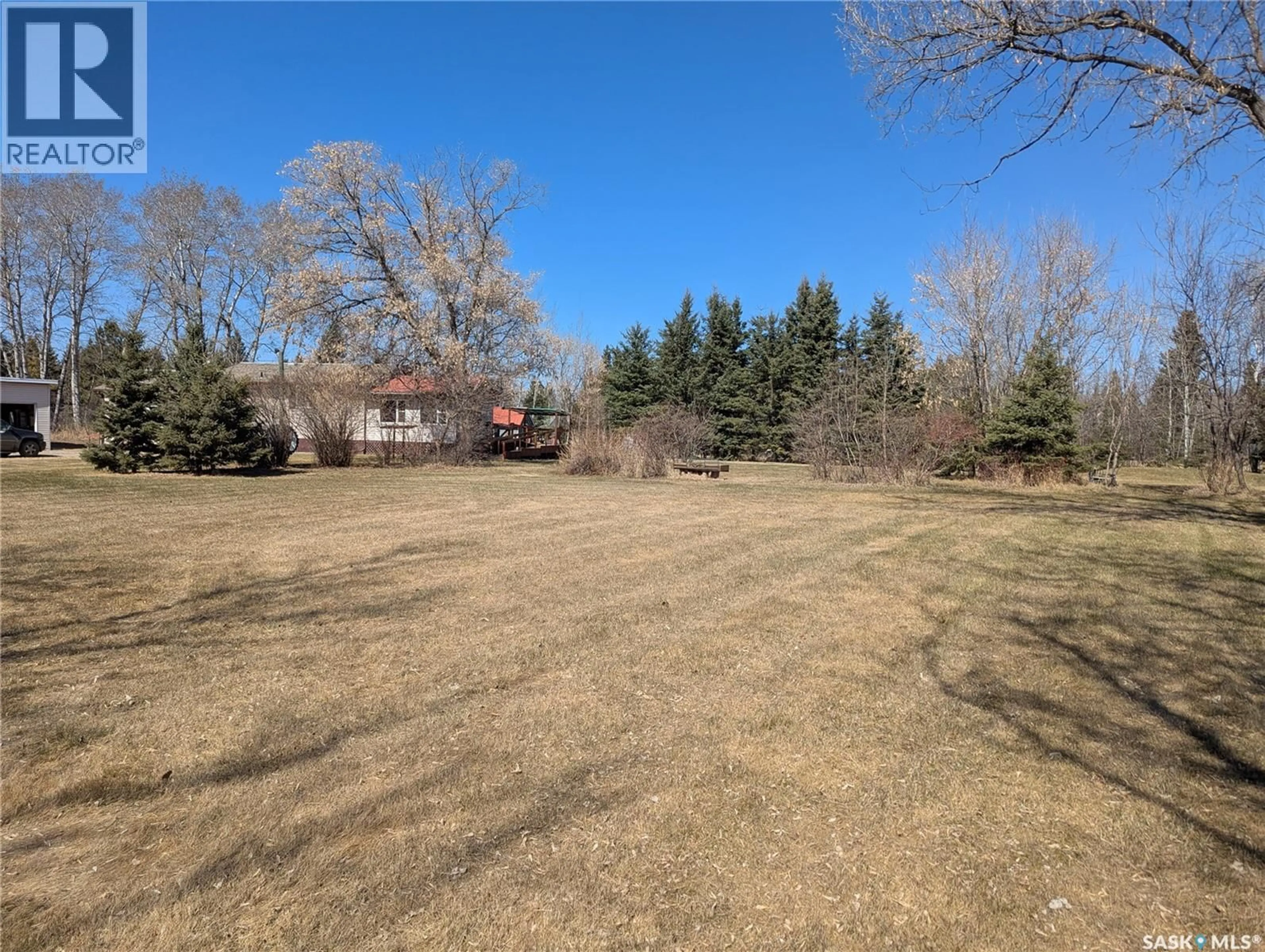 A pic from outside/outdoor area/front of a property/back of a property/a pic from drone, forest/trees view for 129 LEMIEUX CRESCENT, Leoville Saskatchewan S0J1N0