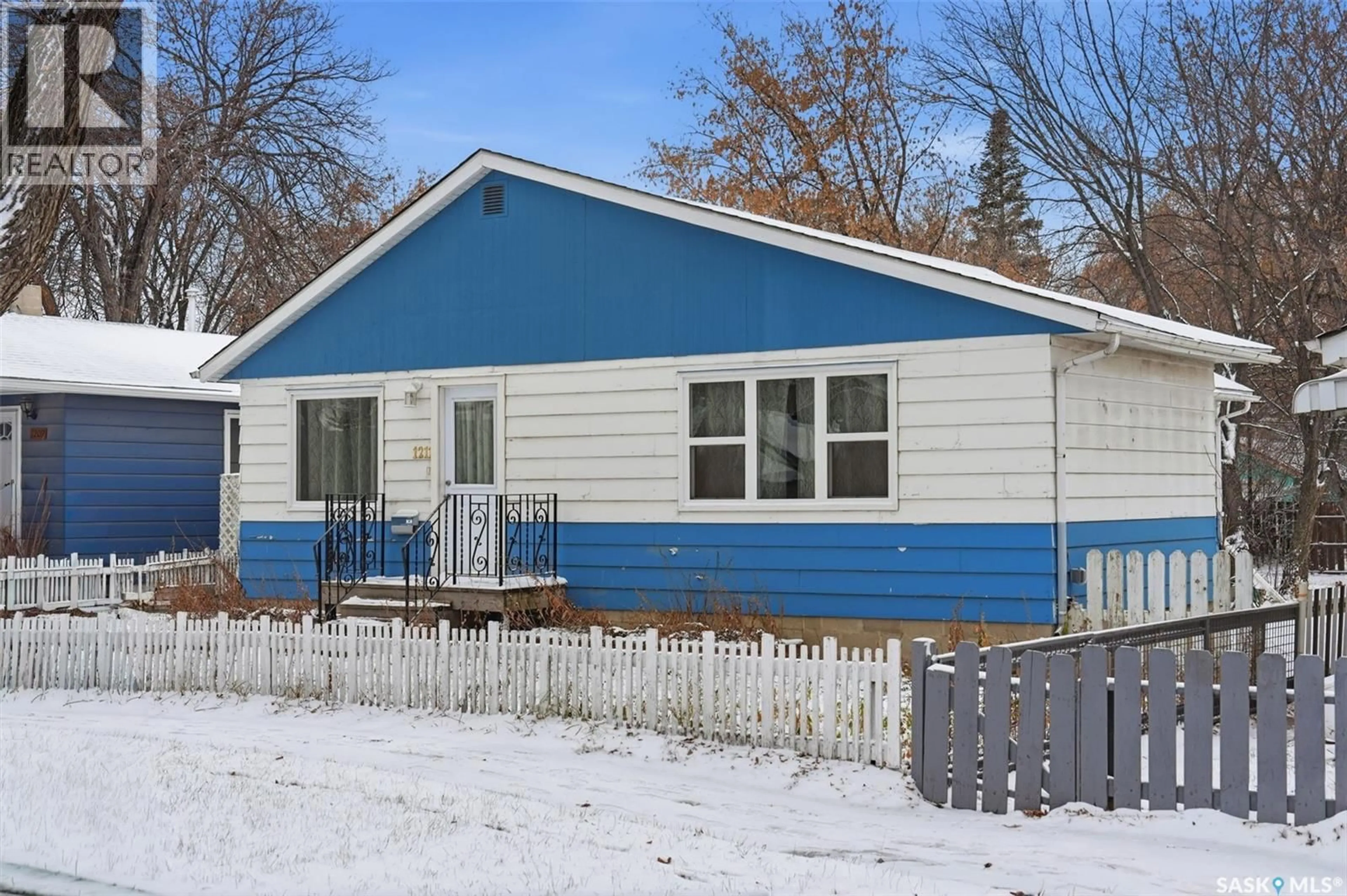 Home with vinyl exterior material, street for 1211 D AVENUE, Saskatoon Saskatchewan S7L1N9