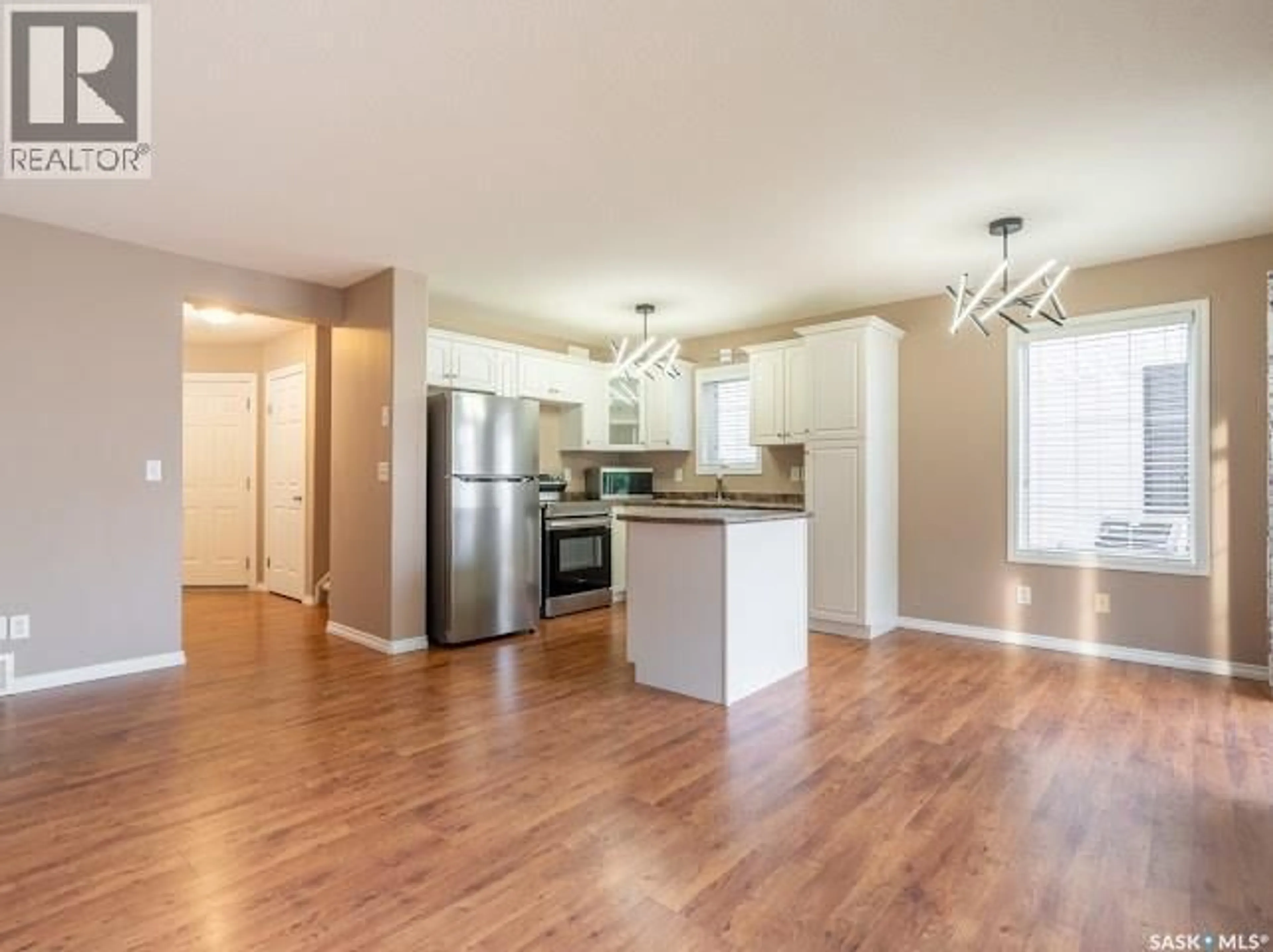 Open concept kitchen, wood/laminate floor for 43 2400 TELL PLACE, Regina Saskatchewan S4V2Z4