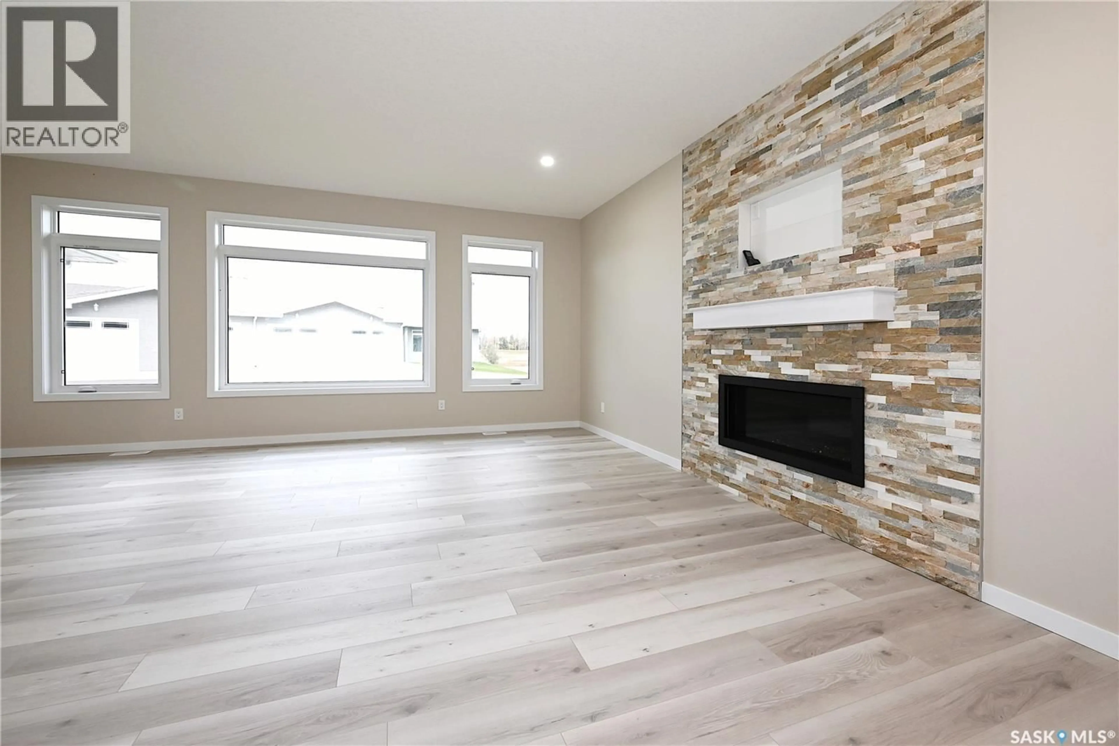 Living room with furniture, wood/laminate floor for 10 2330 MORSKY DRIVE, Estevan Saskatchewan S4A3A5