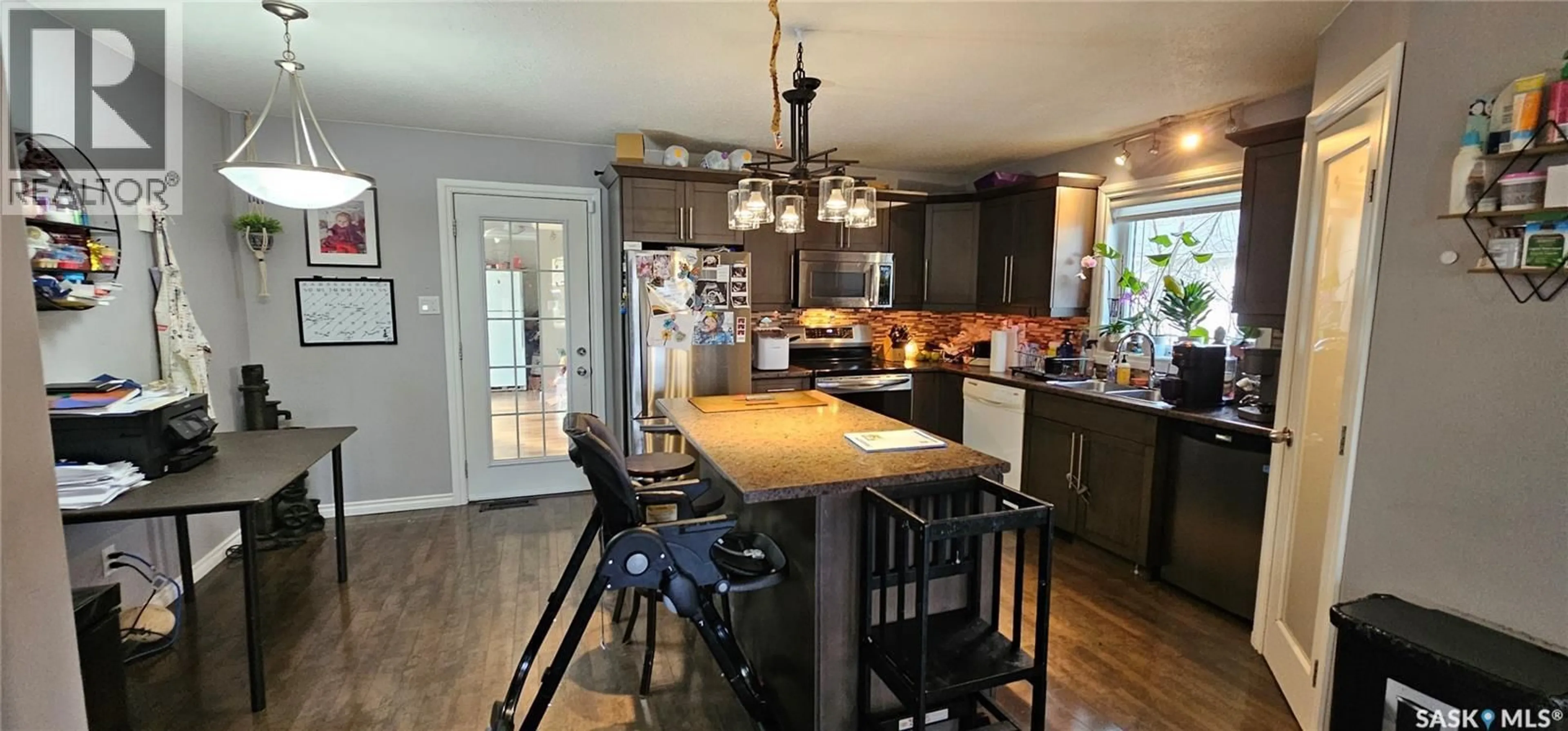 Open concept kitchen, wood/laminate floor for 914 108TH AVENUE, Tisdale Saskatchewan S0E1T0