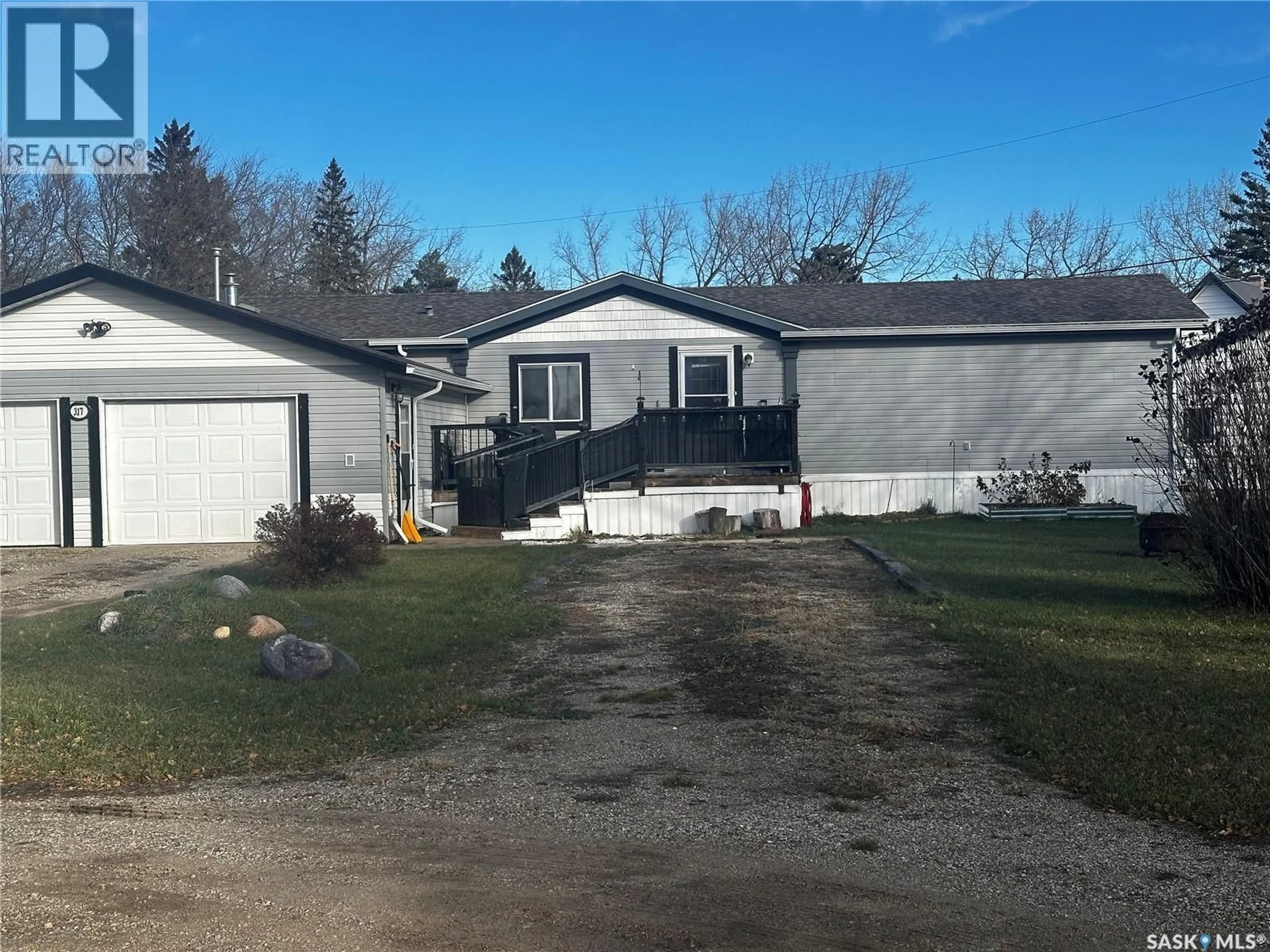 A pic from outside/outdoor area/front of a property/back of a property/a pic from drone, unknown for 317 RAILWAY CRESCENT, Midale Saskatchewan S0C1S0
