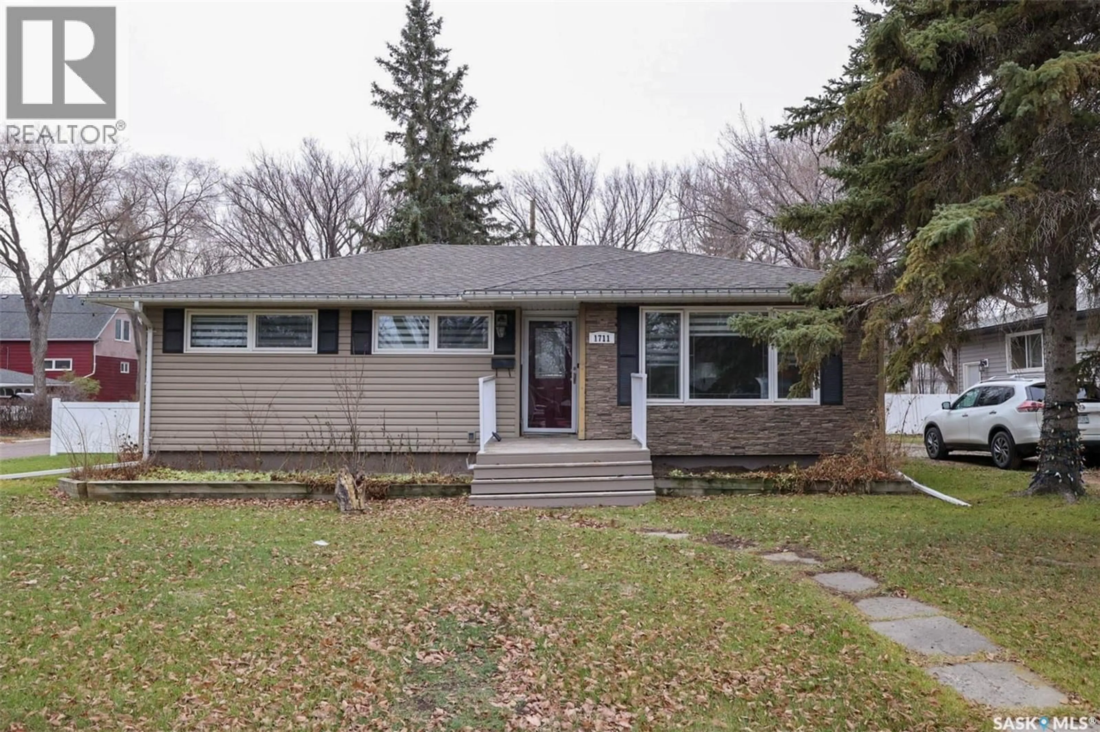 Home with vinyl exterior material, street for 1711 GRANT DRIVE, Regina Saskatchewan S4S4V3