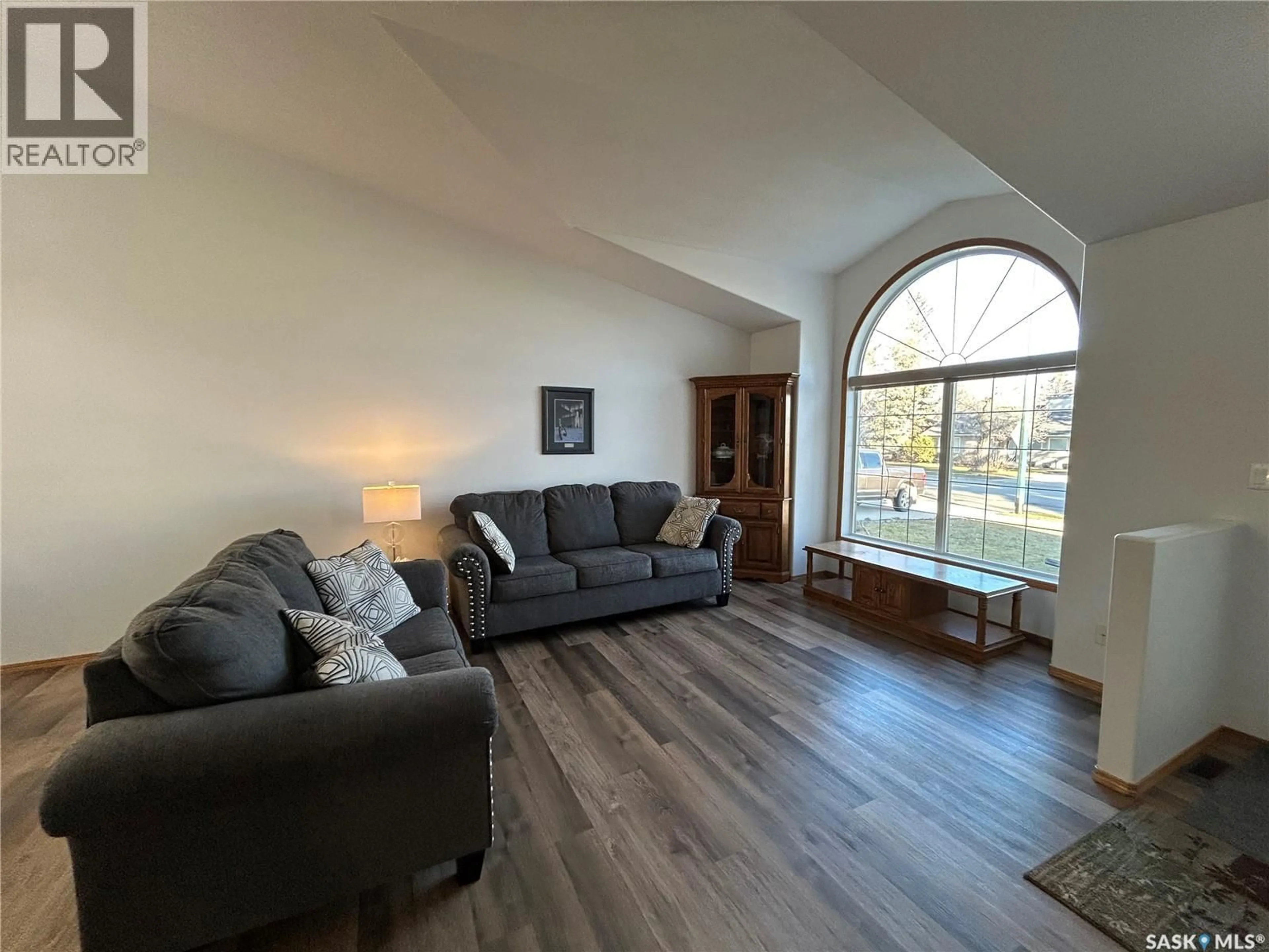 Living room with furniture, wood/laminate floor for 713 9TH STREET, Humboldt Saskatchewan S0K2A0