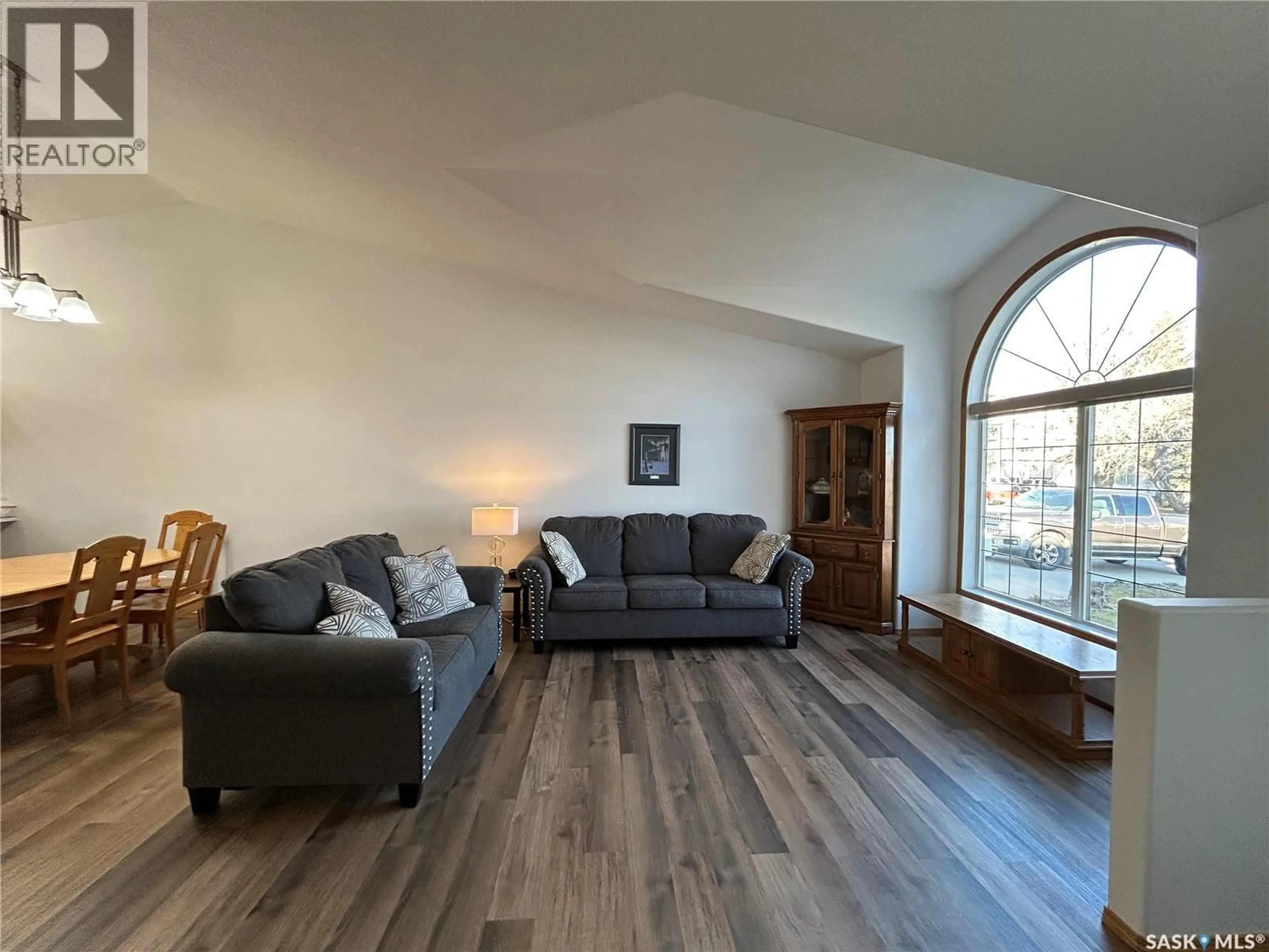 Living room with furniture, wood/laminate floor for 713 9TH STREET, Humboldt Saskatchewan S0K2A0