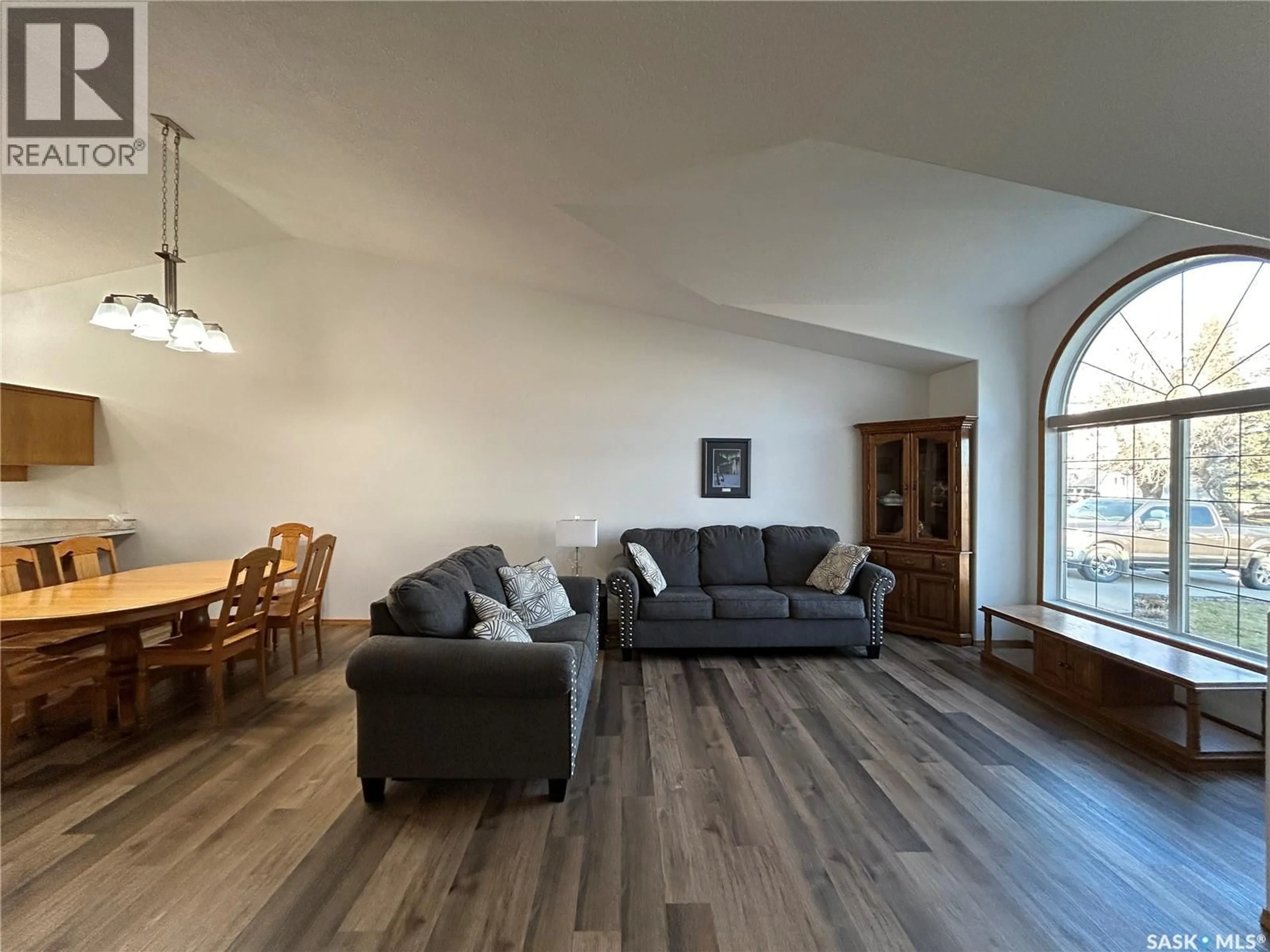 Living room with furniture, wood/laminate floor for 713 9TH STREET, Humboldt Saskatchewan S0K2A0