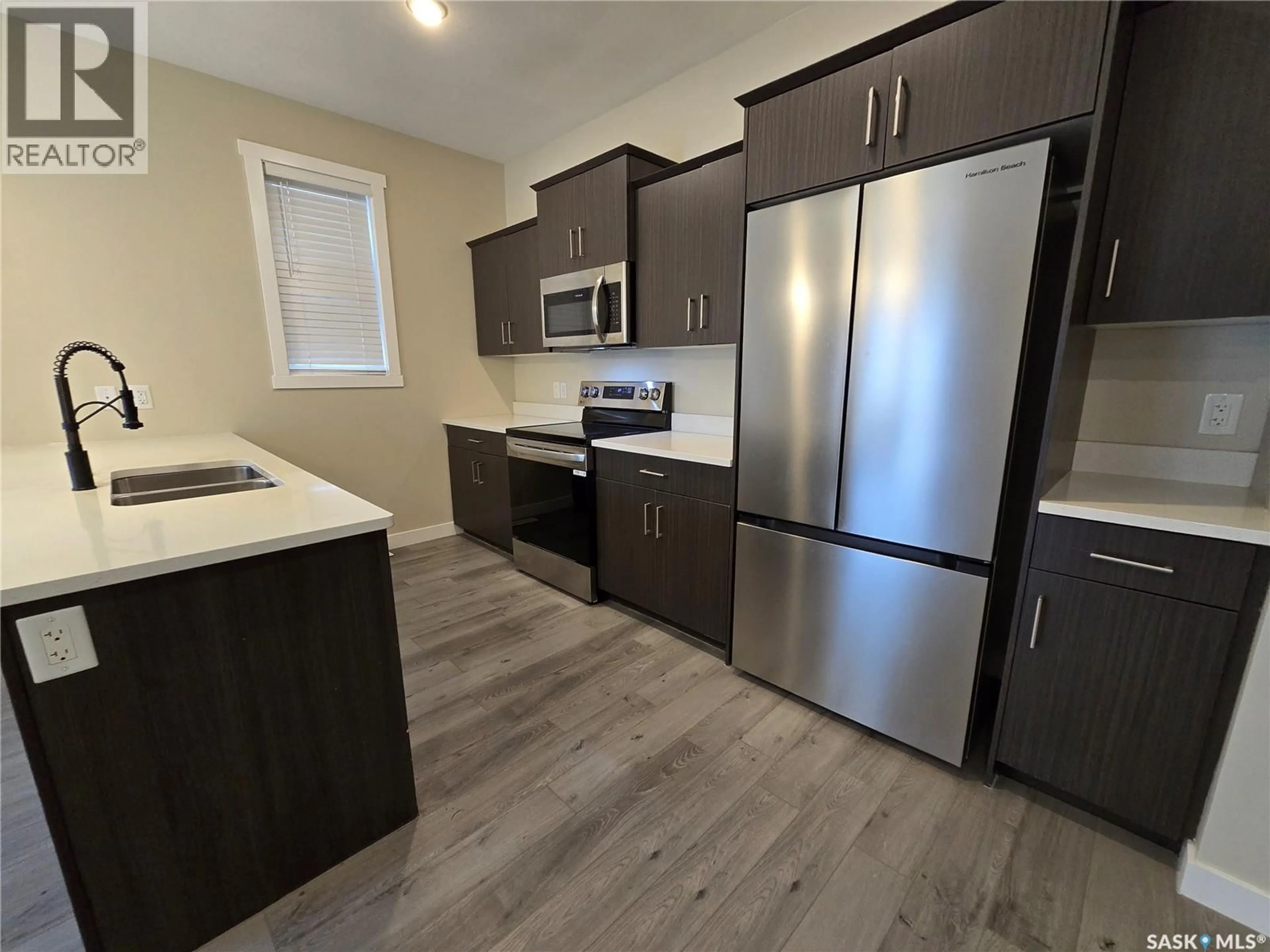 Open concept kitchen, wood/laminate floor for 315 - 127 DICKSON CRESCENT, Saskatoon Saskatchewan S7T0Z1