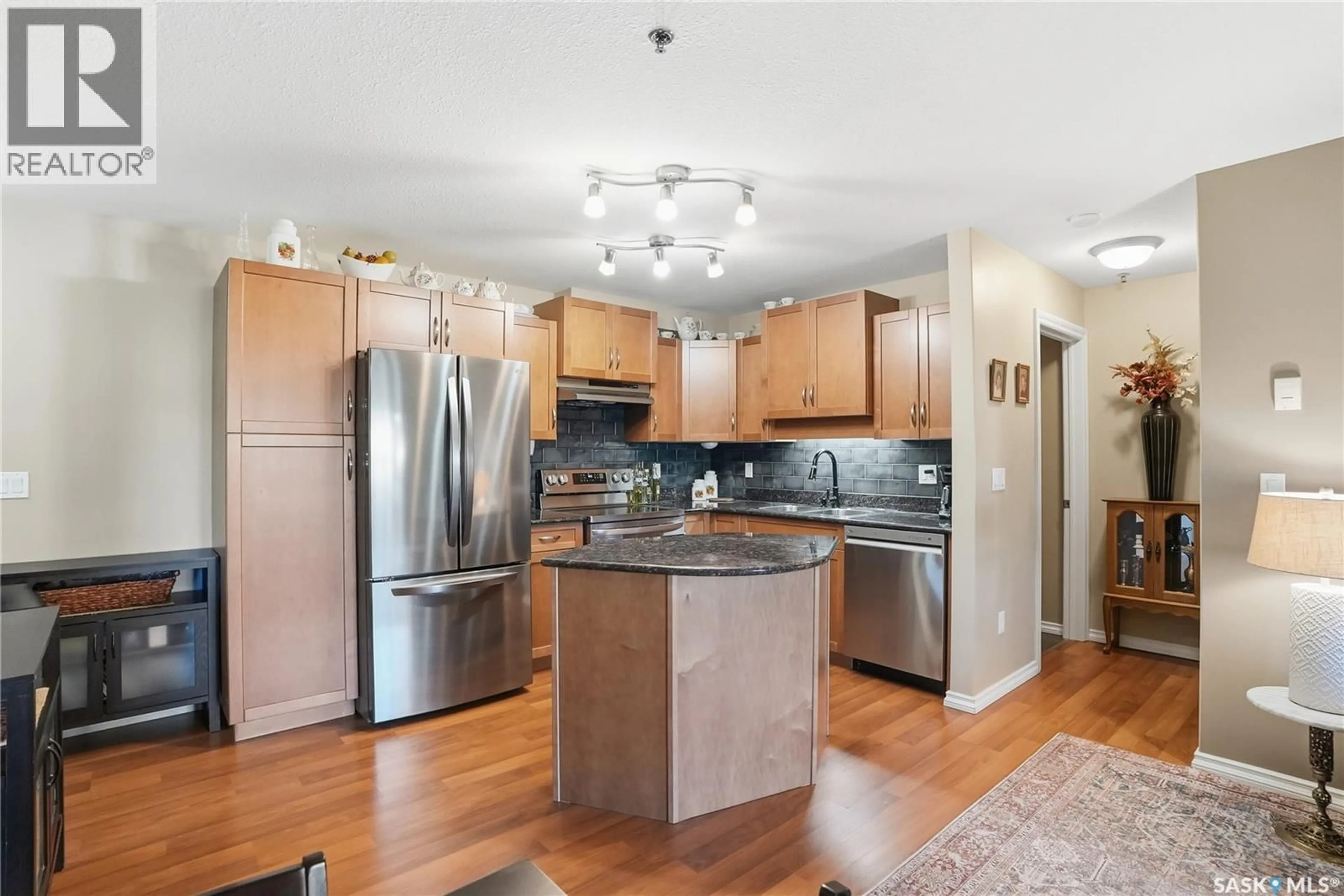 Open concept kitchen, wood/laminate floor for 103 - 326 HEROLD ROAD, Saskatoon Saskatchewan S7V0A2