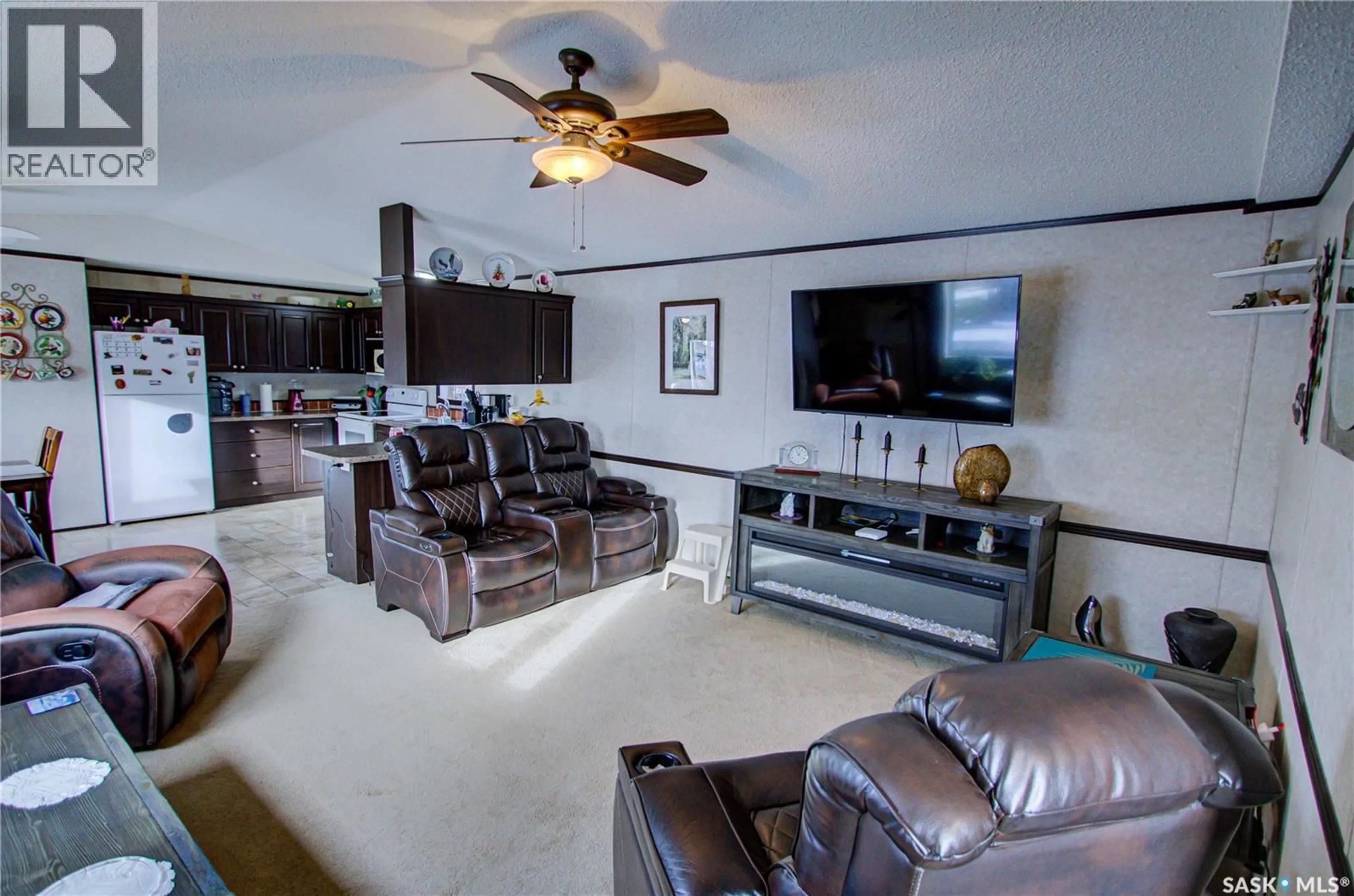 Living room with furniture, ceramic/tile floor for 105 RUTTLE AVENUE, Kinistino Saskatchewan S0J1H0